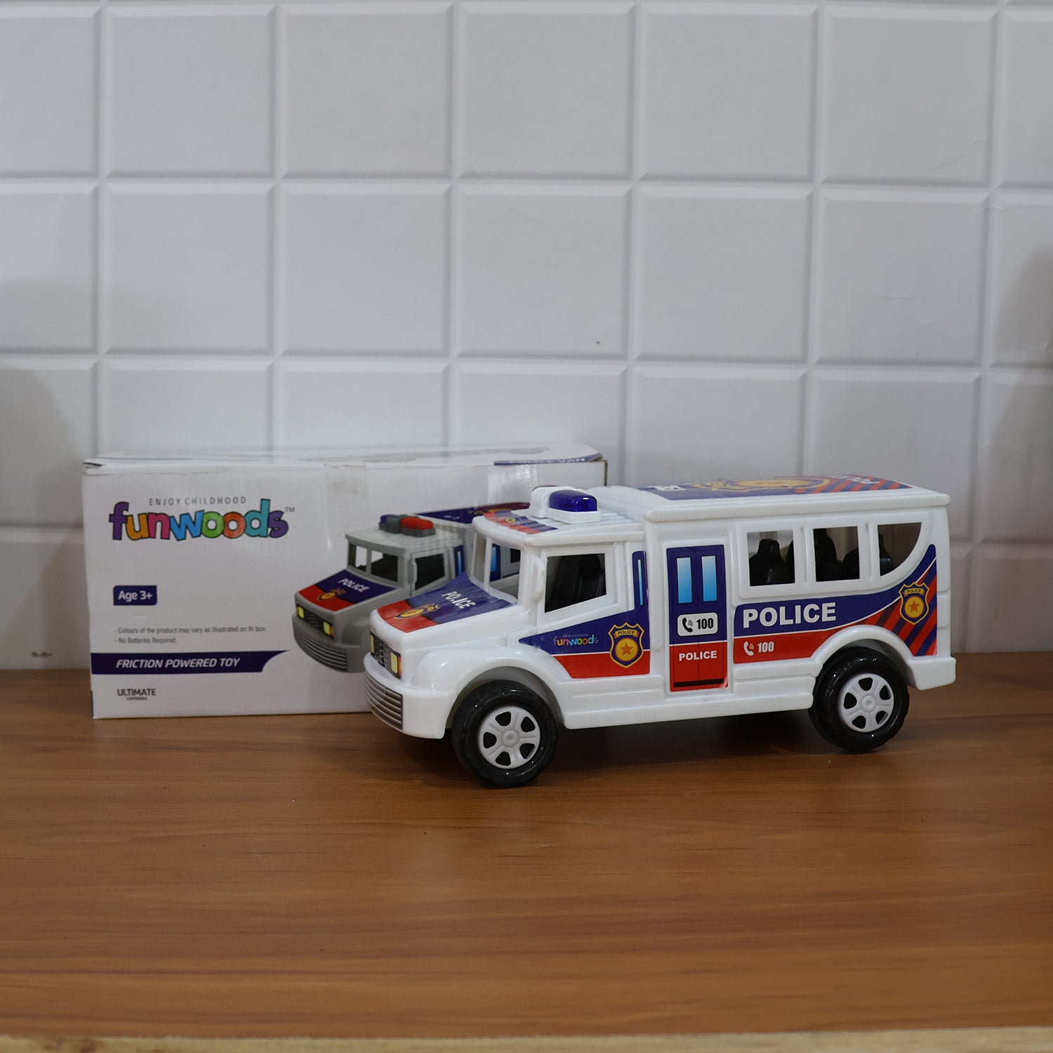 Child playing with the Police Van Toy demonstrating friction powered movement