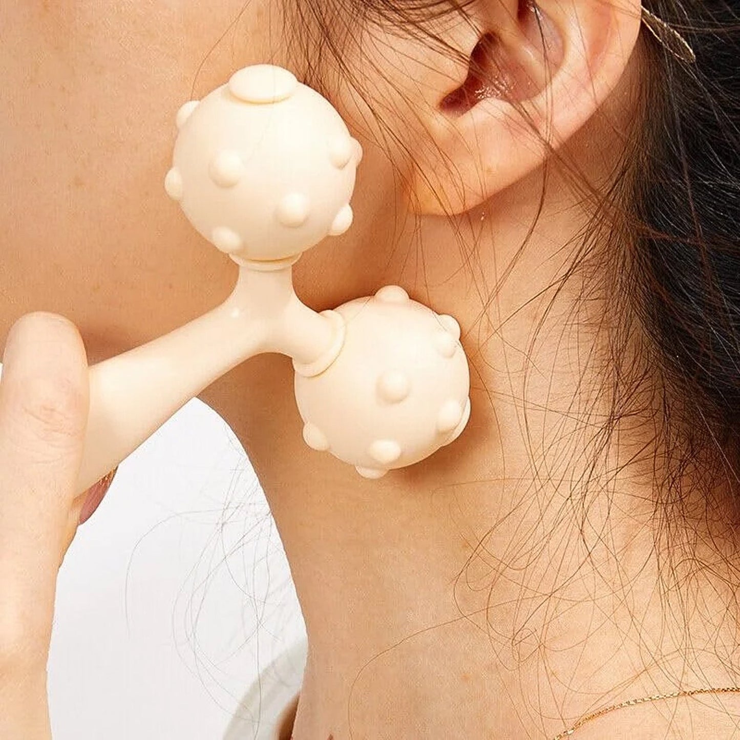 Close-up of dual ball massage tool for skin relaxation and circulation
