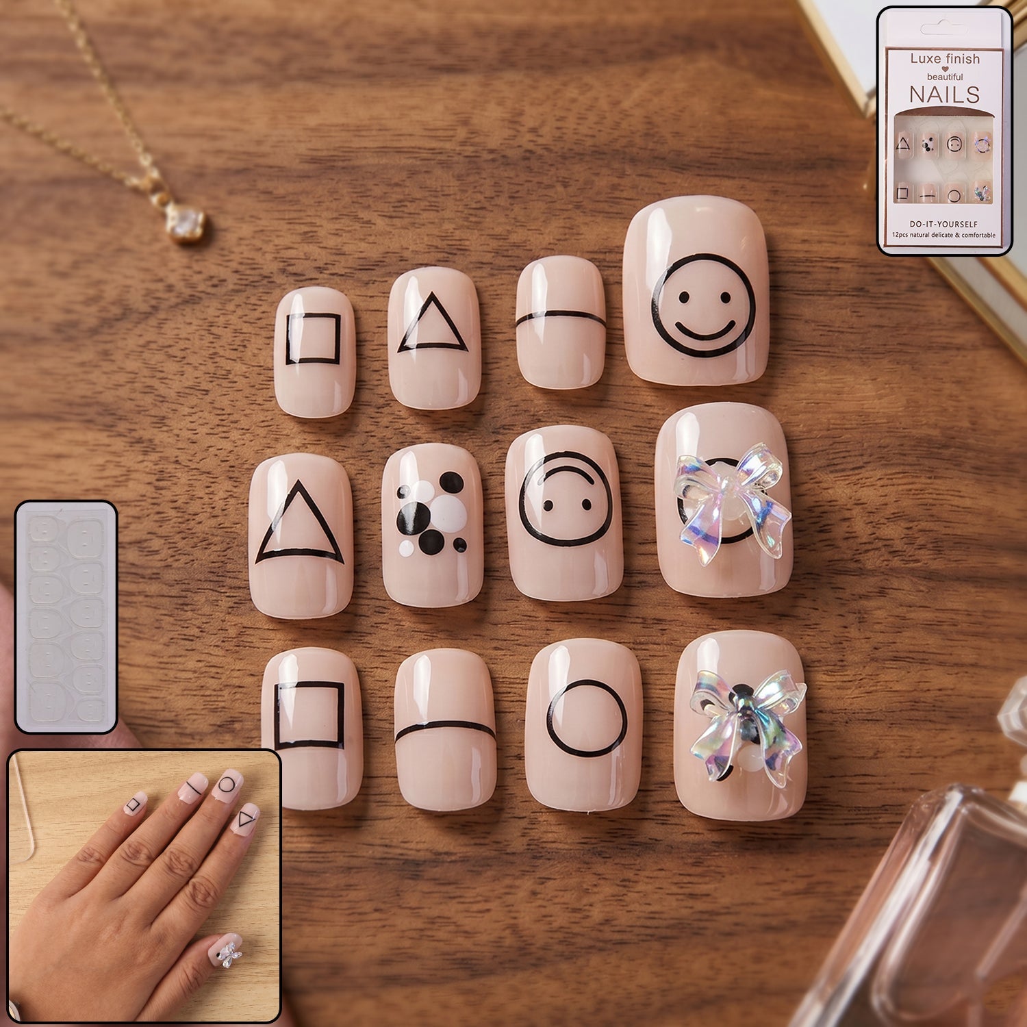 A set of 12 short, square, nude press-on nails with various black geometric shapes and two with iridescent bows.