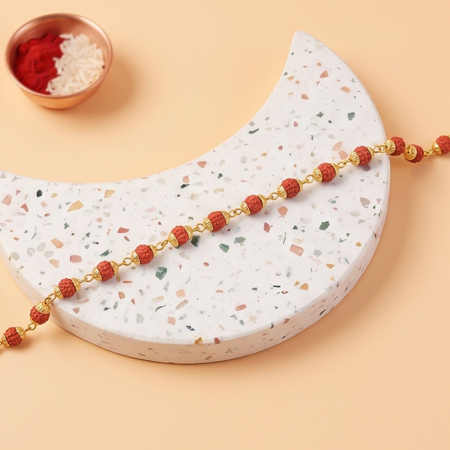 Rudraksha bead bracelet rakhi displayed on a flat surface from above.