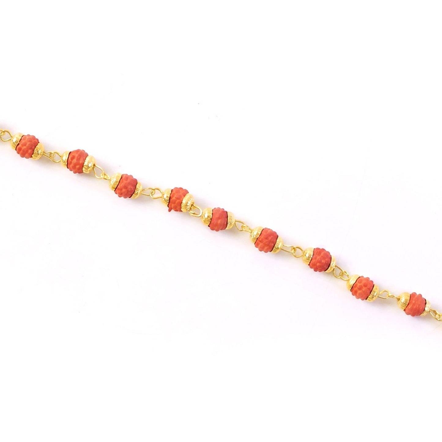 Rudraksha bead rakhi with gold plated elements presented on a dark background.
