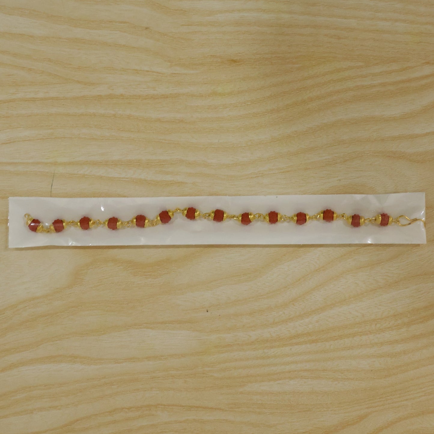 Rudraksha bead rakhi shown in a gift box packaging for Raksha Bandhan.