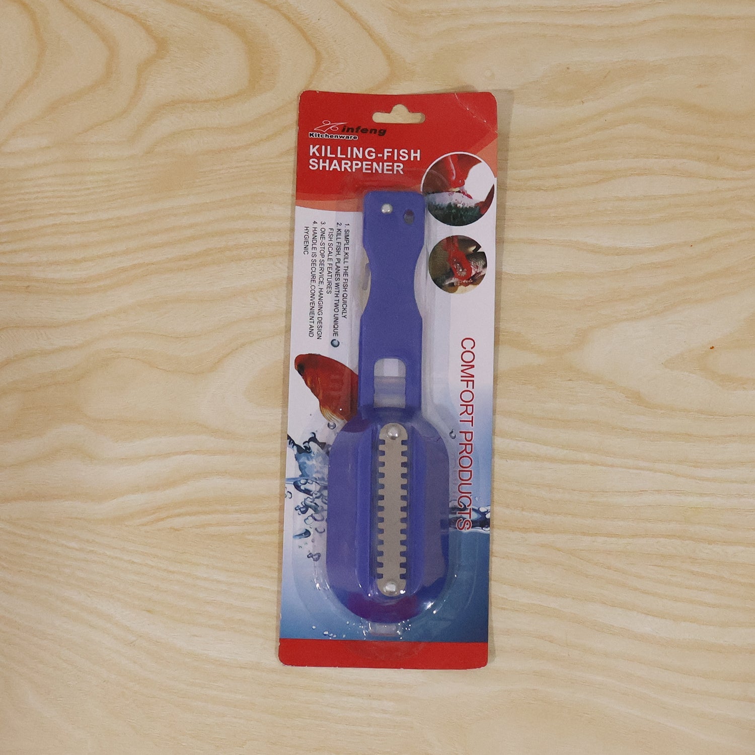 A person holds a blue fish scaler with a clear lid, actively scaling a fish on a wooden cutting board.