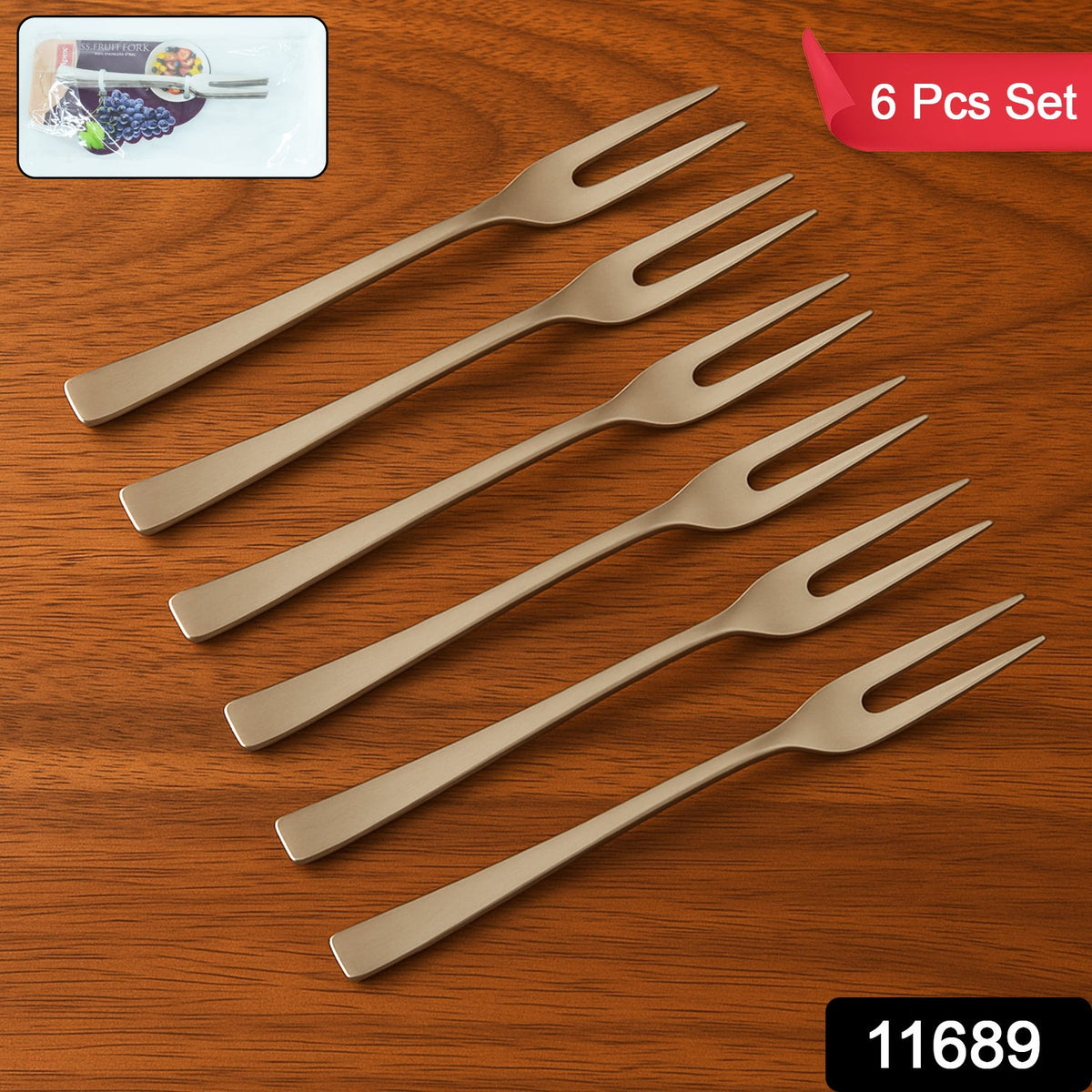 Six silver stainless steel fruit forks arranged diagonally on a wooden surface, with a 6 Pcs Set label.