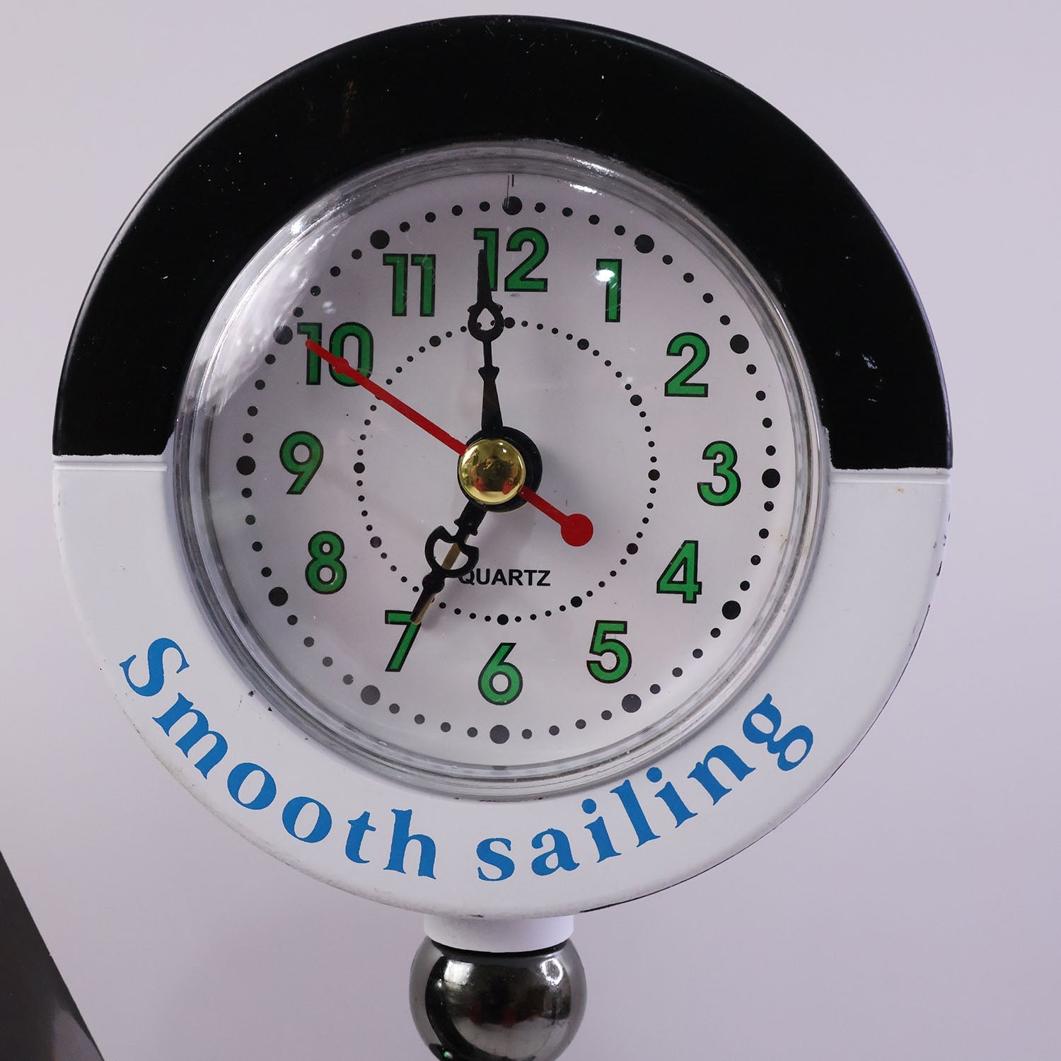 Ship shape clock lamp lit on table showing warm LED ambiance