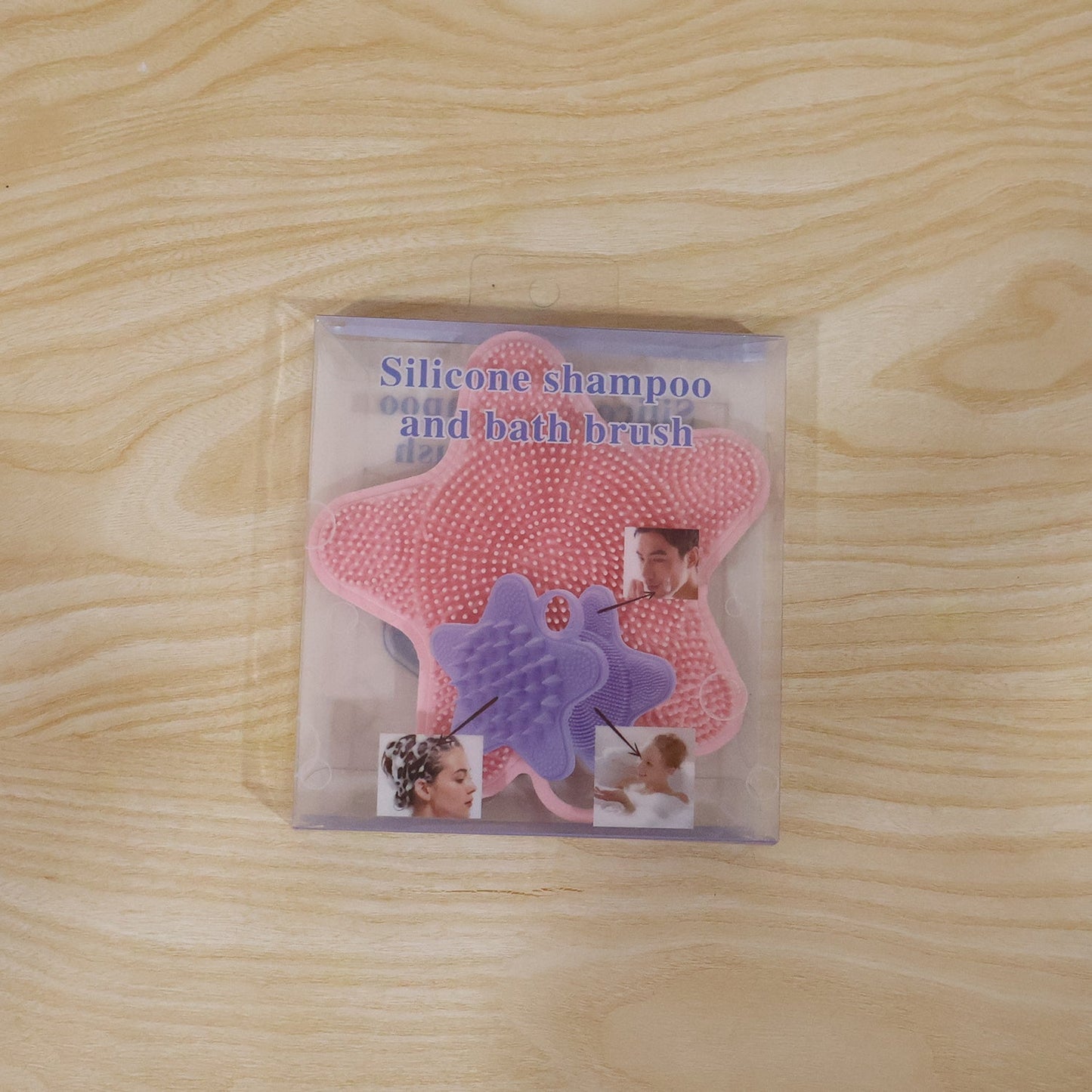 A pink silicone starfish-shaped brush is visible inside clear plastic packaging, featuring images of people using it on a