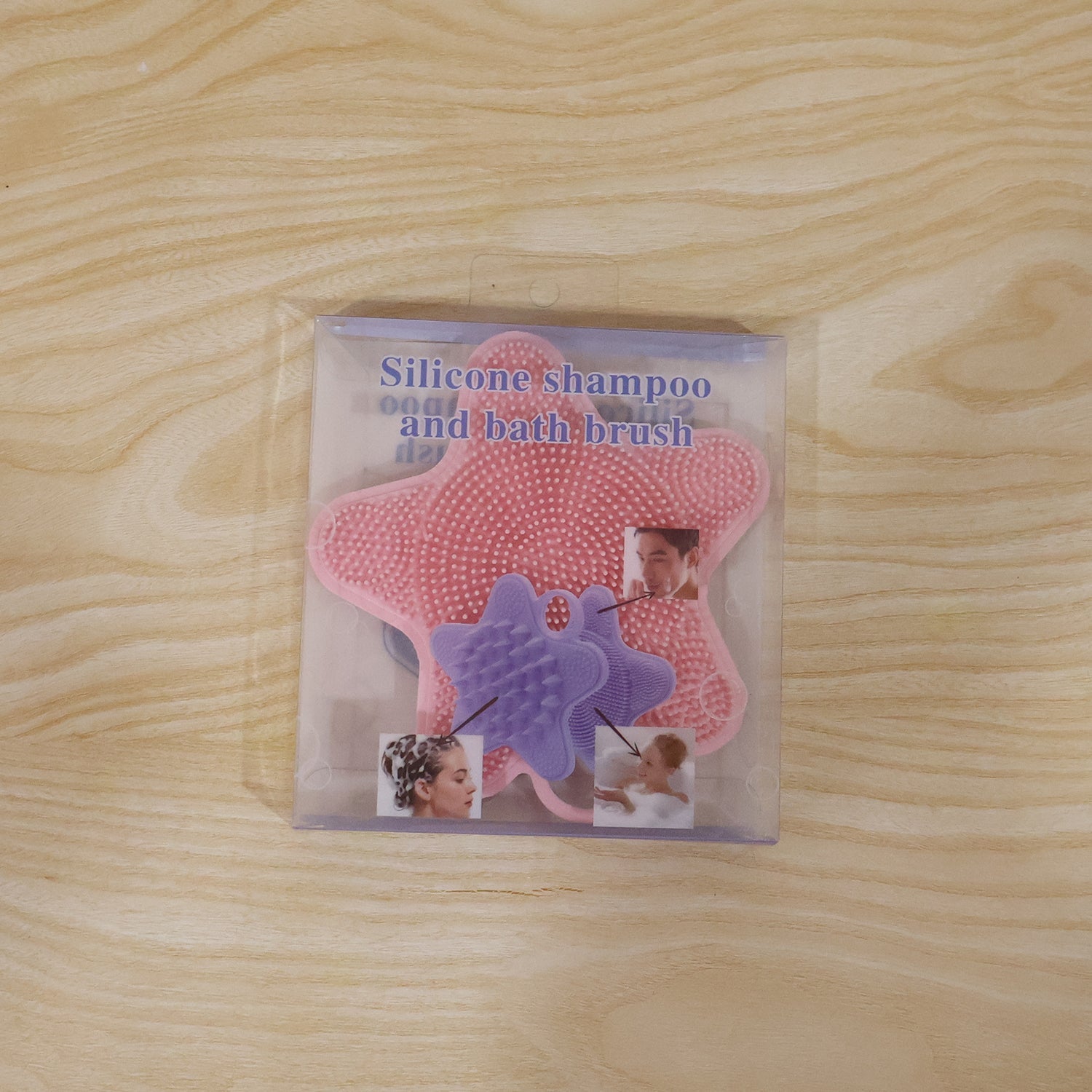 A pink silicone starfish-shaped brush is visible inside clear plastic packaging, featuring images of people using it on a