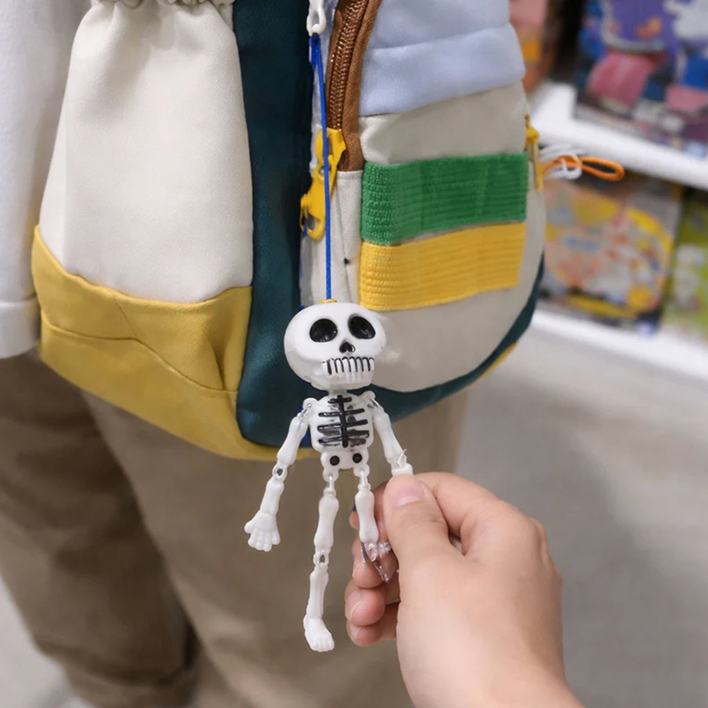 Metal hook keychain attached to a skeleton figure