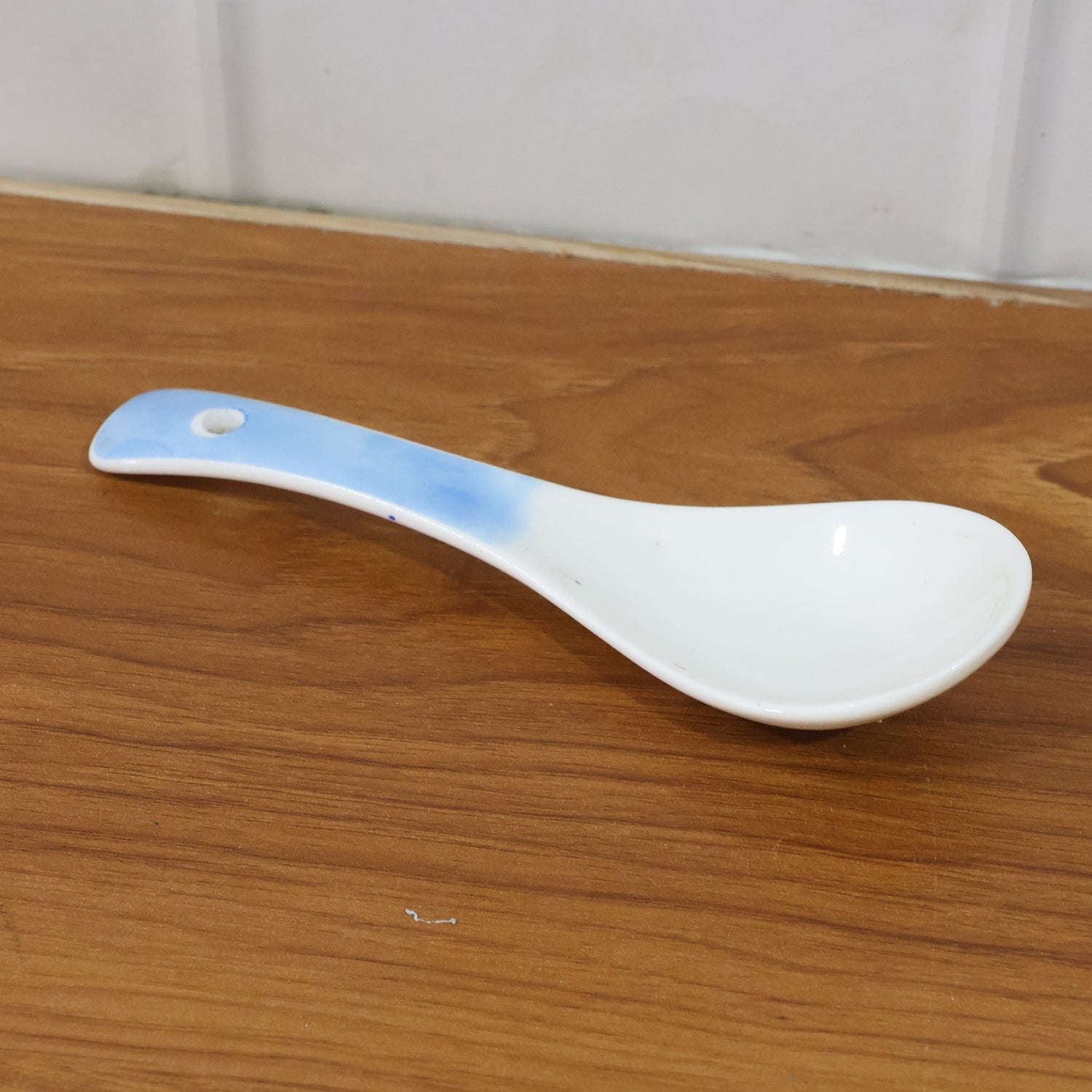 Heat-resistant ceramic spoon being used to serve food