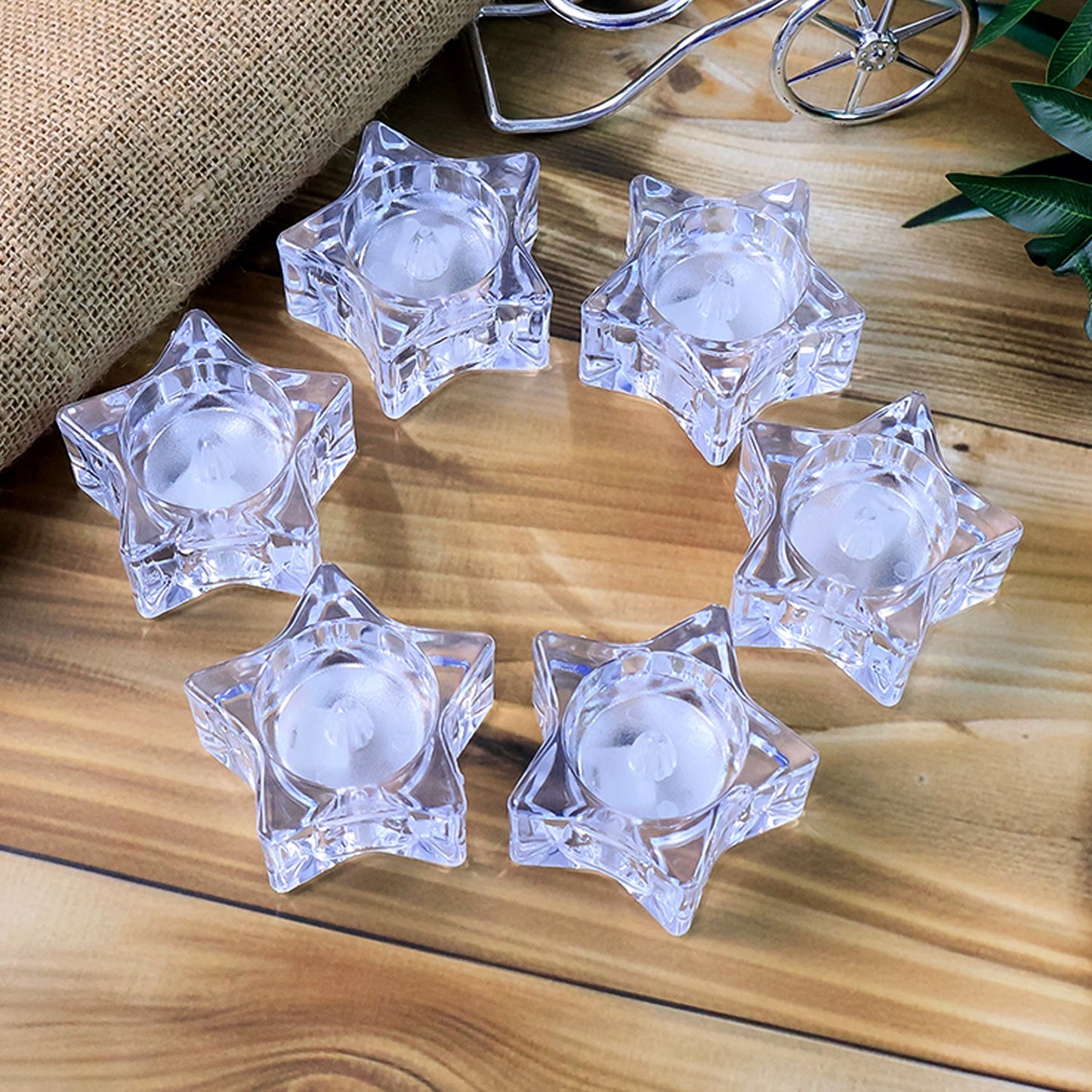 Close-up of star-shaped holders with battery operated LED candles
