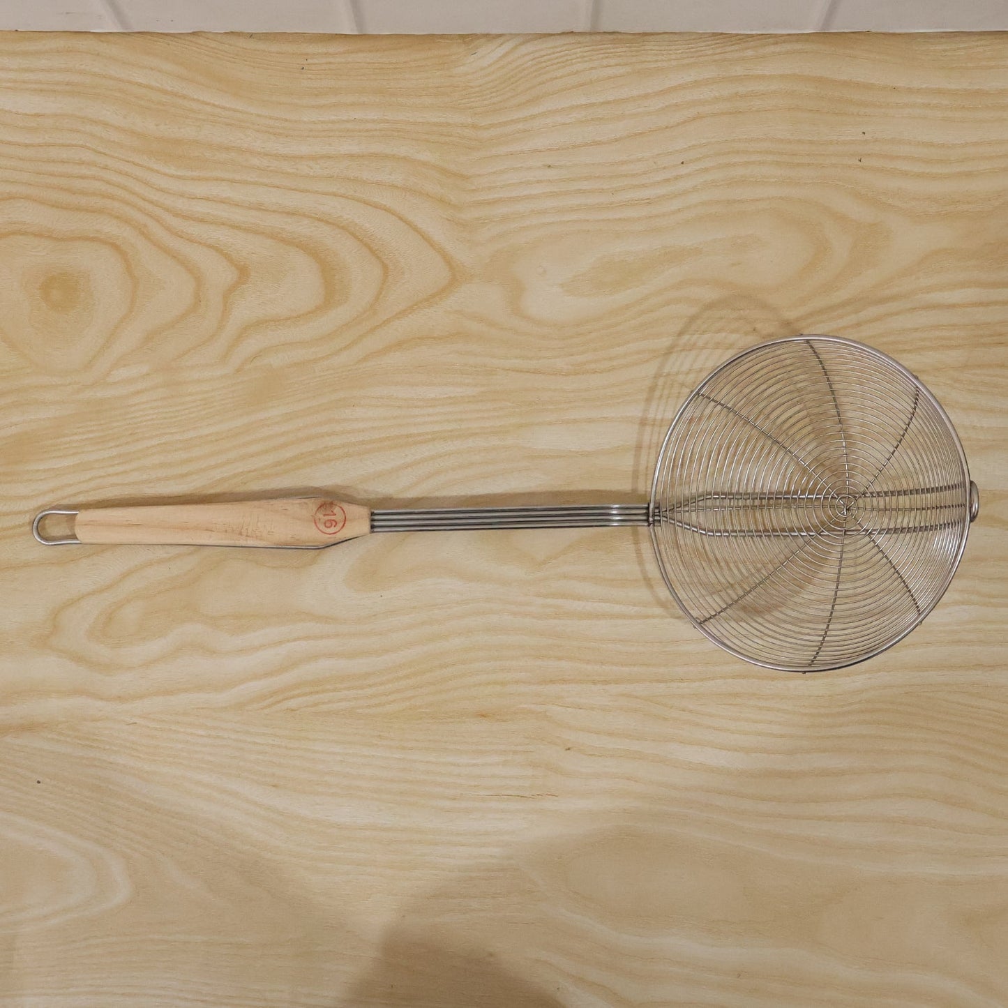 Cooking strainer utensil with long wooden handle for efficient frying