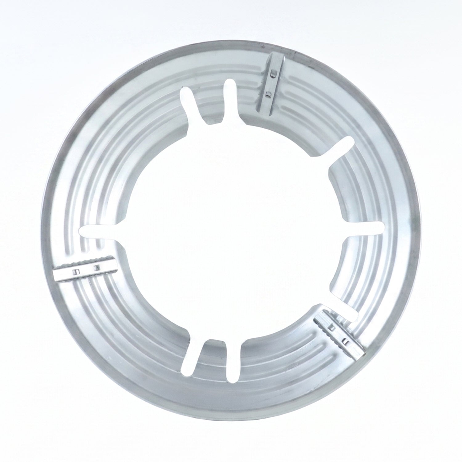 A top-down view of the circular silver gas stove trivet with six inner supports.