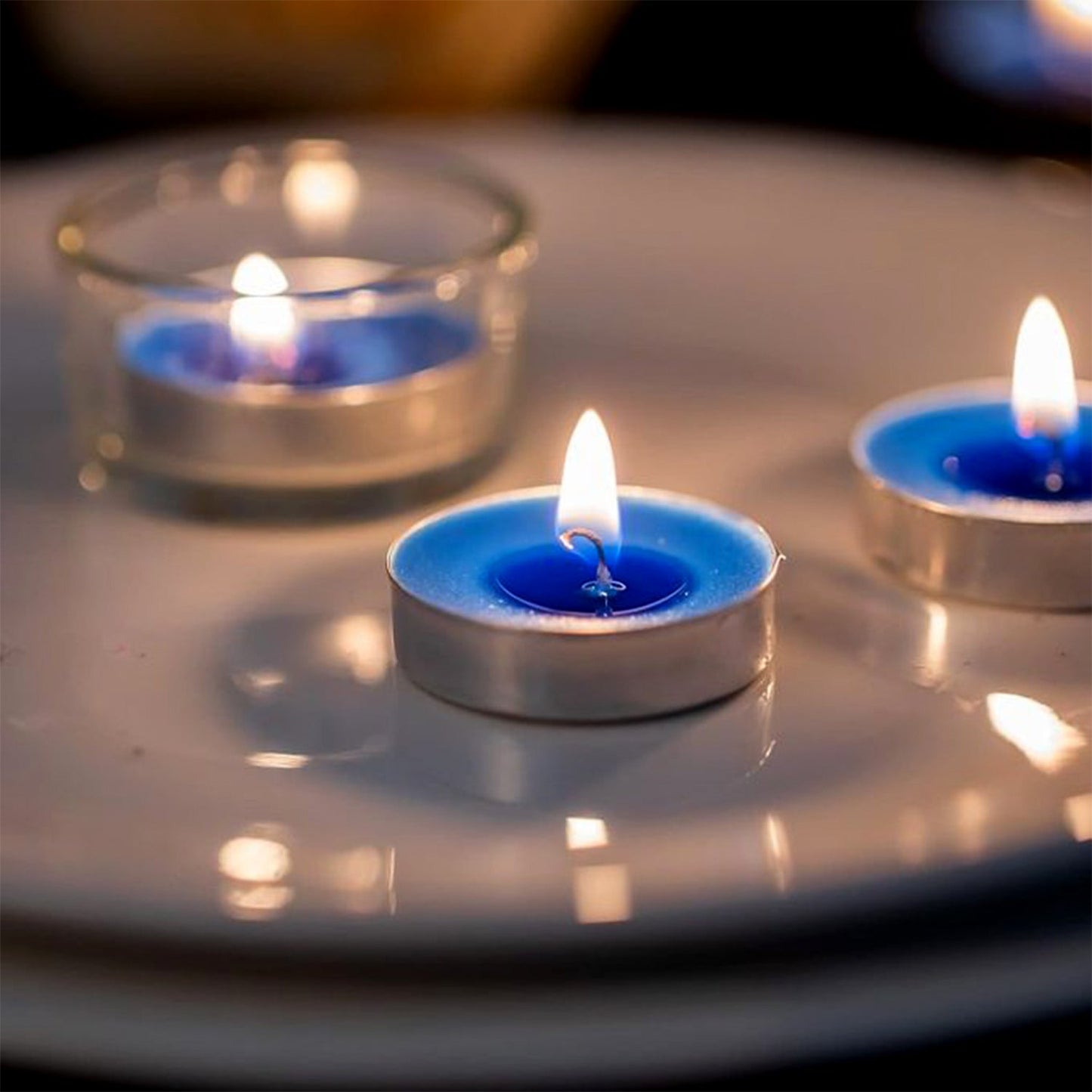 Assorted scented tea light candles arranged for festive and home décor