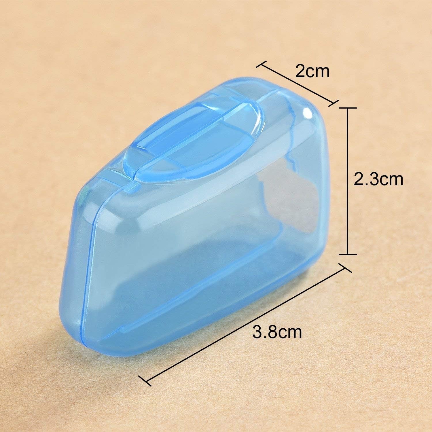 A single translucent blue toothbrush head cover is shown with dimensions of 3.8cm, 2.3cm, and 2cm.