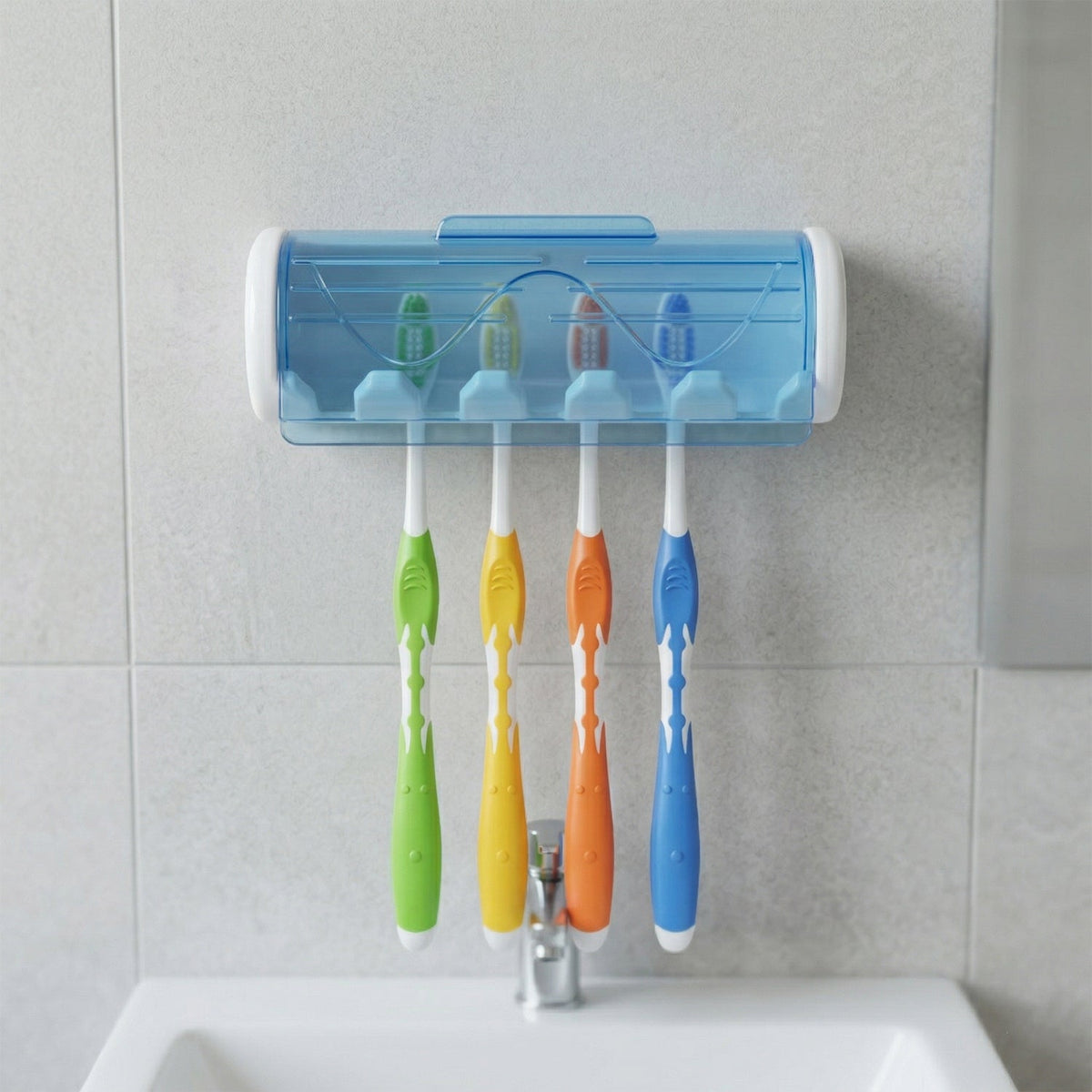 White and blue wall-mounted toothbrush holder with four colorful toothbrushes above a bathroom sink.