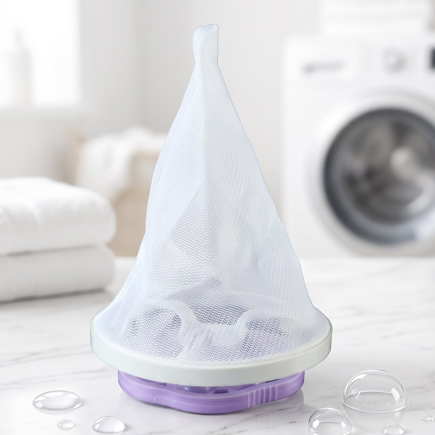 A purple and white floating lint mesh bag on a white counter with a washing machine in the background.