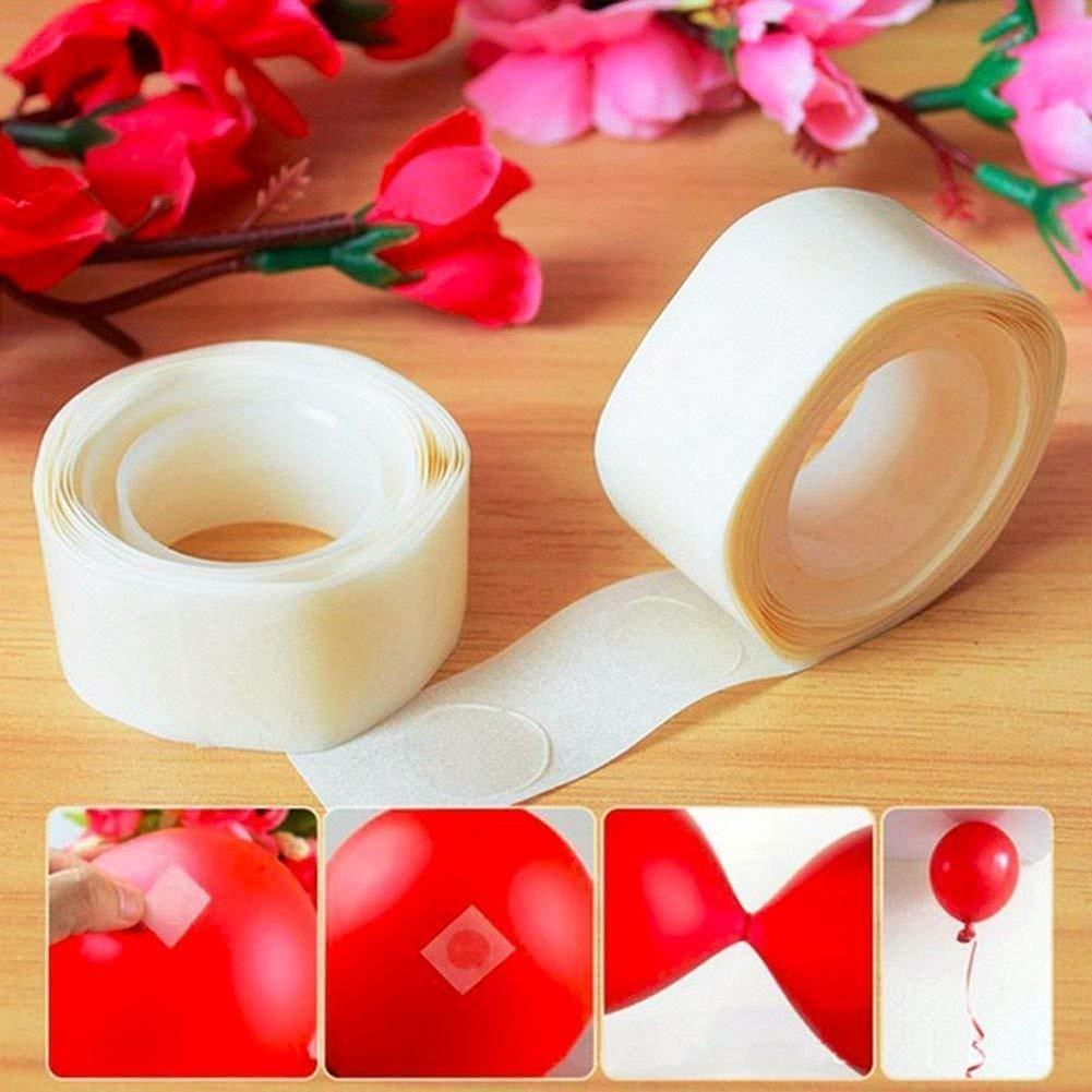 Two rolls of clear glue dots with examples of their use on red balloons, against a backdrop of red flowers.