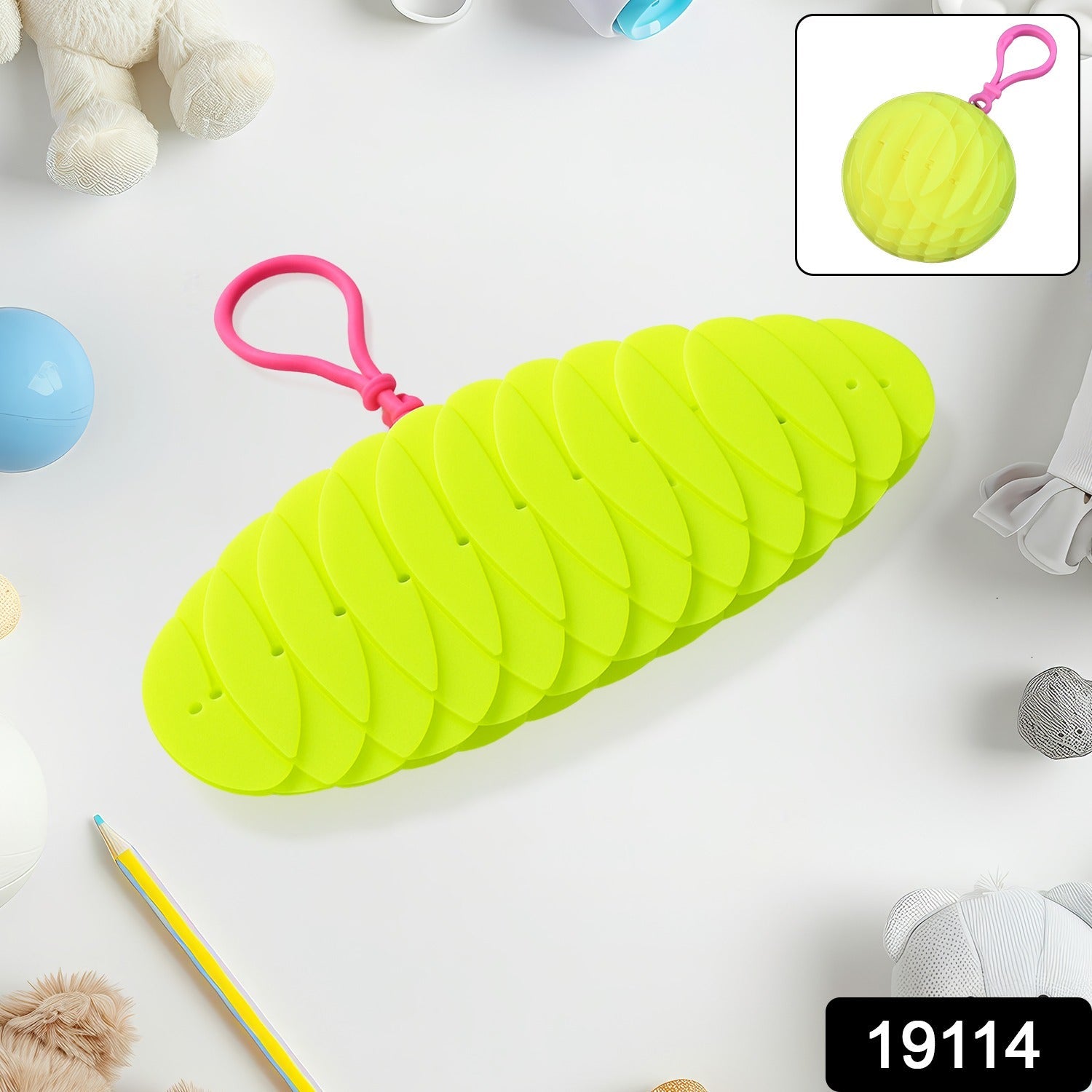 A bright green collapsible silicone ball keychain with a pink loop, shown partially collapsed on a white surface with toys