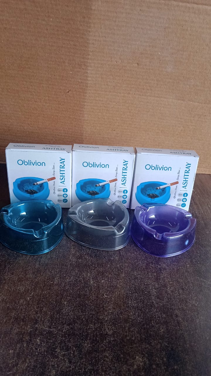 A transparent plastic ashtray with three cigarette grooves for table use is shown in this product photo (1 Pc).