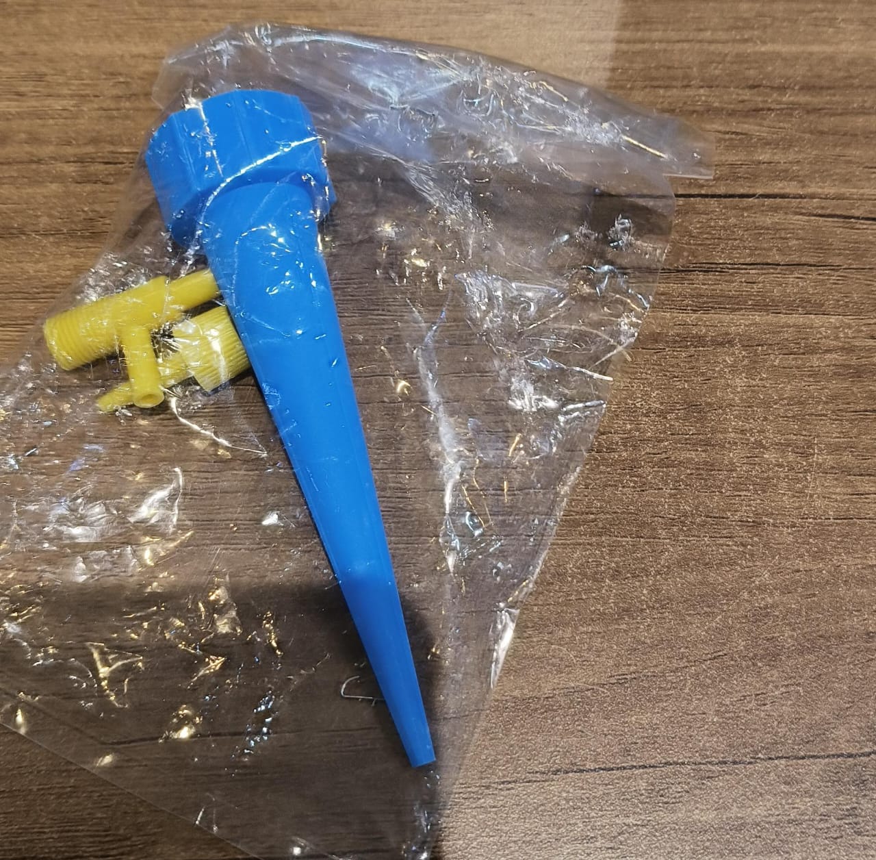 Plant watering spike tool in blue, ensuring slow water drip to roots
