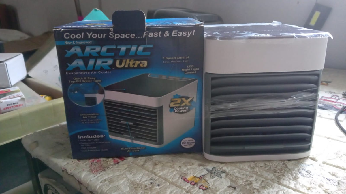 Compact portable personal air cooler with LED, perfect for a bedside table.