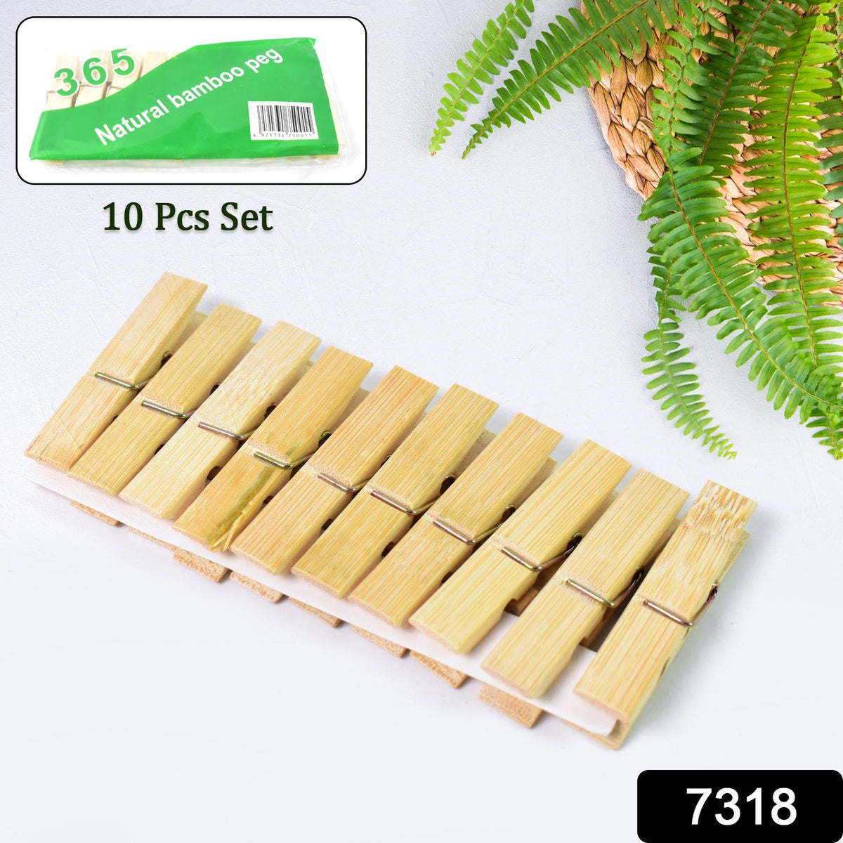 Ten bamboo clothes pegs displayed on a white surface with a green package labeled "Natural bamboo peg".