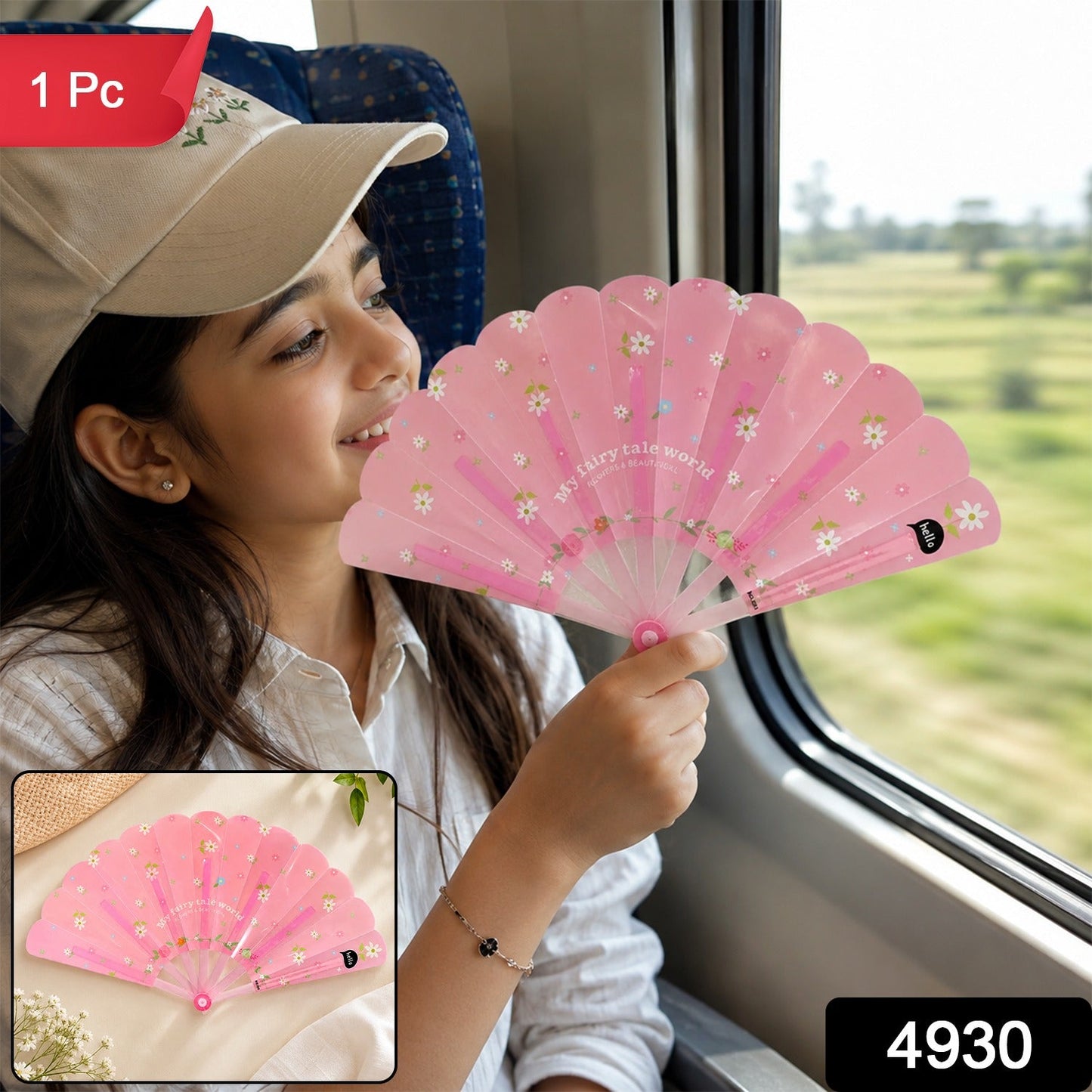 A pink foldable fan with white daisy patterns is shown closed on a two-tone blue and gray background.