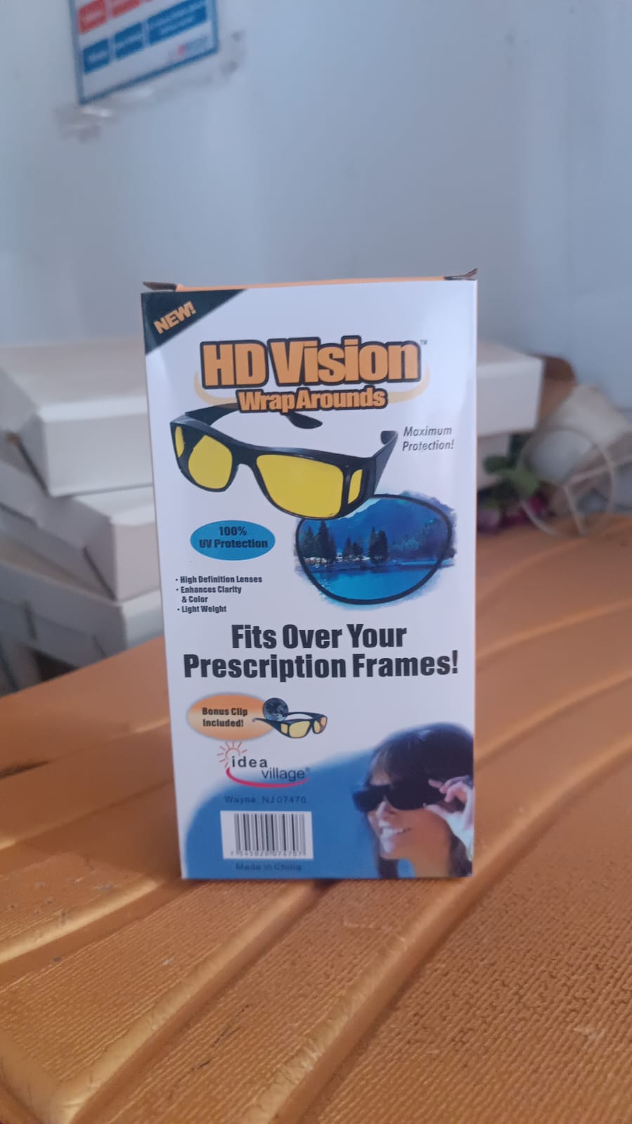 A white retail box for "HD Vision WrapArounds" glasses, showing product features and images of the glasses.