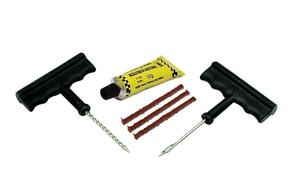 A tire repair kit featuring two T-handle tools, a yellow tube of rubber solution, and three brown repair strips.