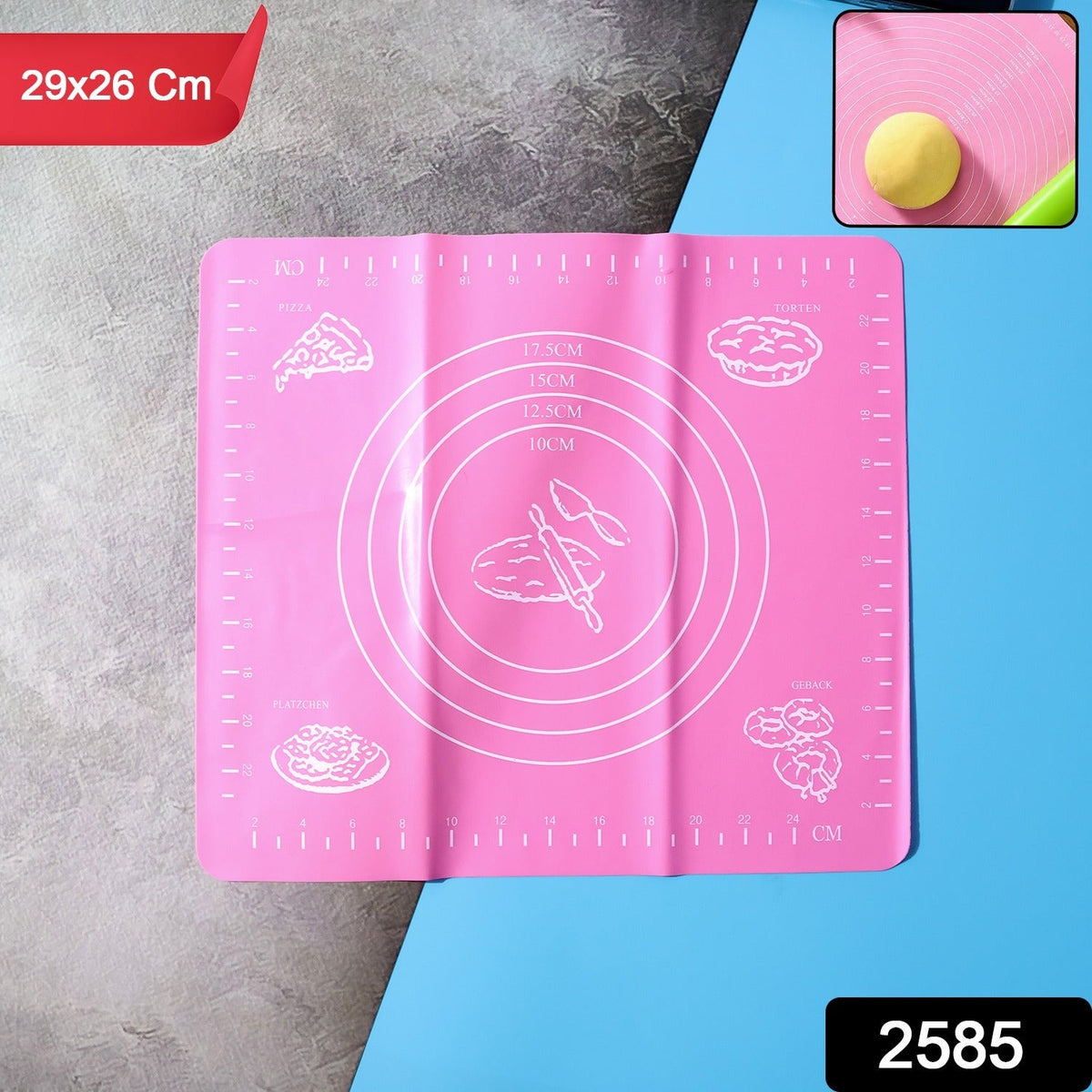 Pink silicone baking mat with white measurement guides and baking illustrations, with a small inset showing dough