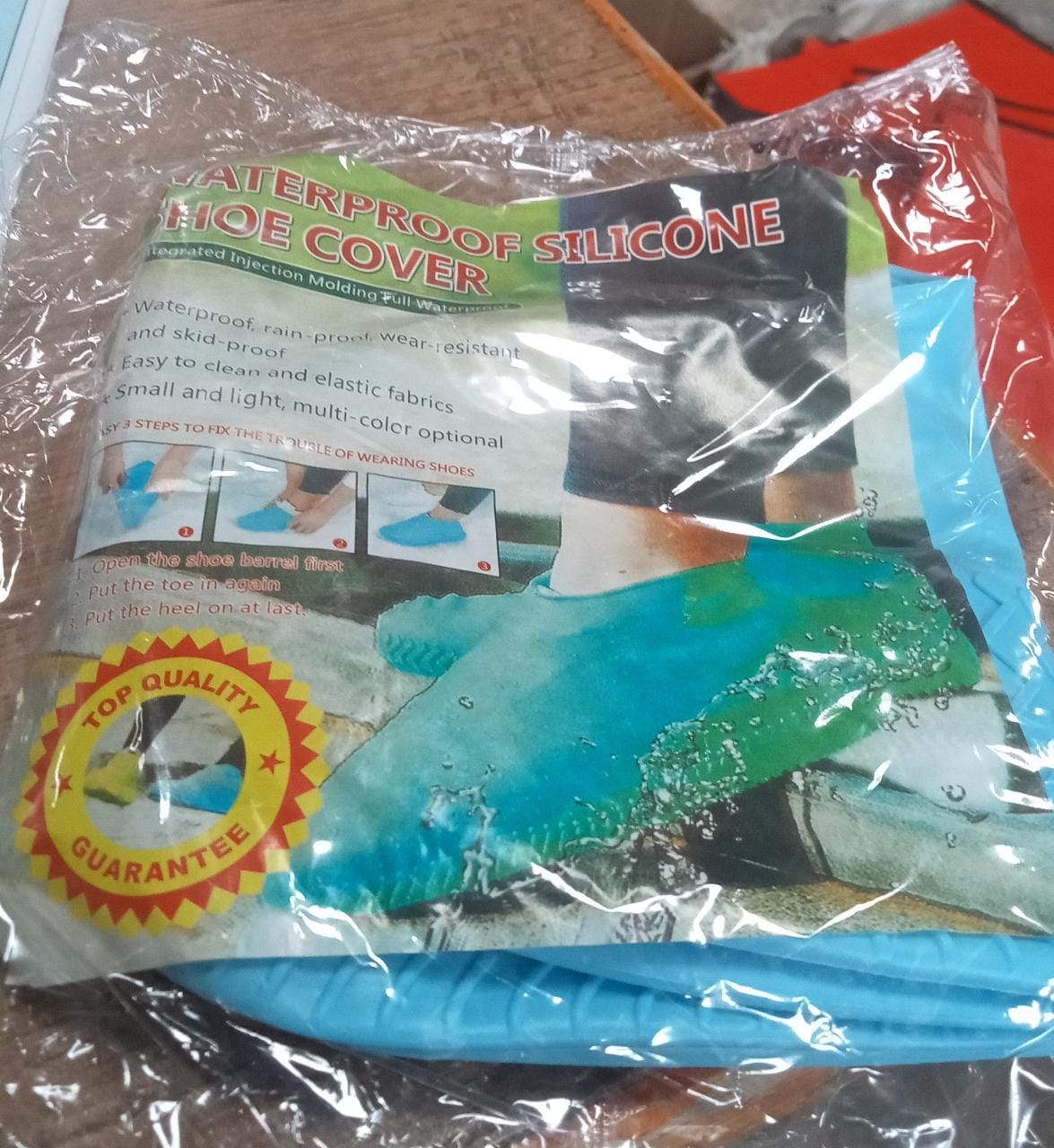 A clear plastic package for waterproof silicone shoe covers, showing product features and usage instructions.