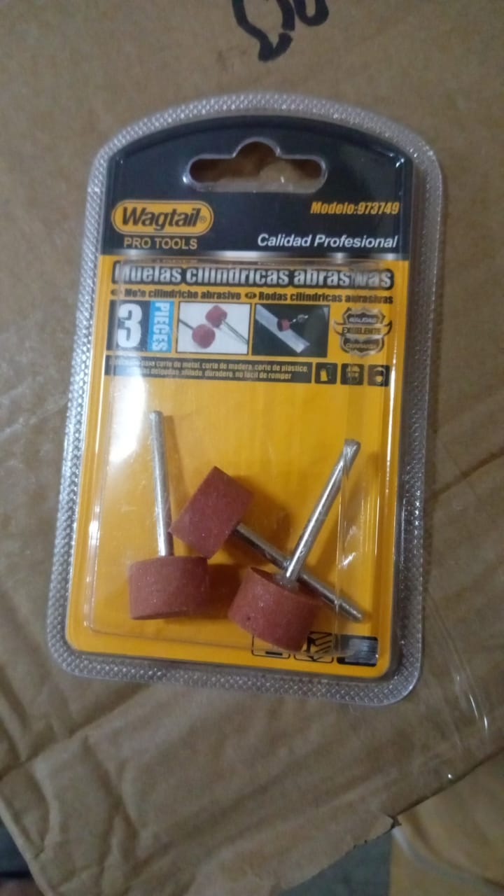 A 3-piece set of cylindrical abrasive grinding wheels in clear blister packaging on a brown cardboard surface.