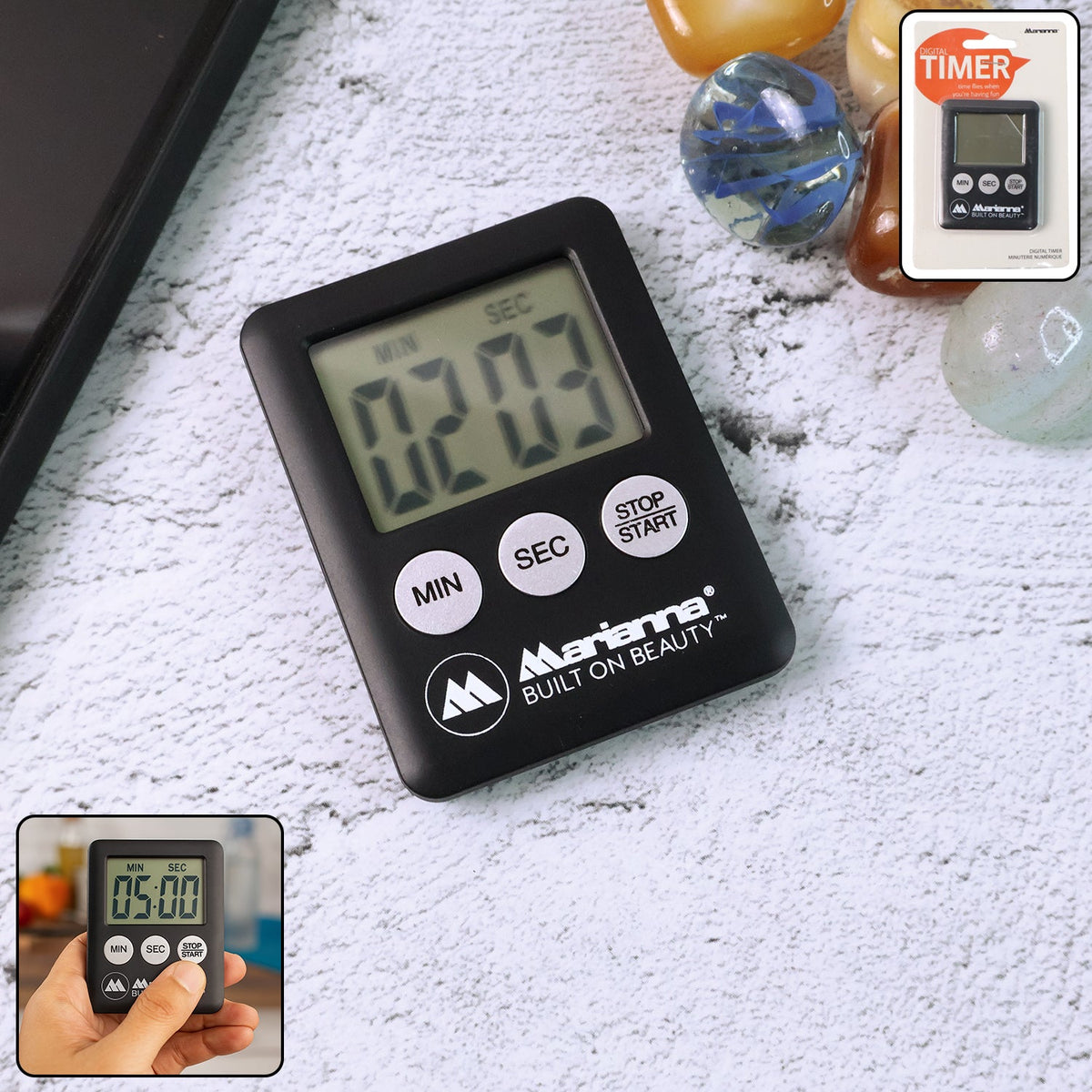 A black digital timer displaying 02:03 on a textured surface, with a small packaged timer and decorative items.
