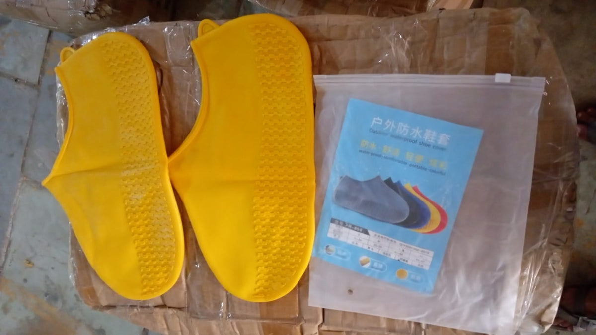 A plastic-wrapped package for a waterproof silicone shoe cover is shown, featuring text and an image of a foot in a blue