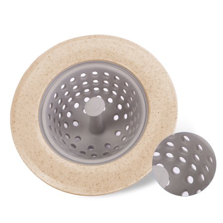 A close-up of a beige and gray round silicone sink strainer with a perforated basket, showing texture detail.