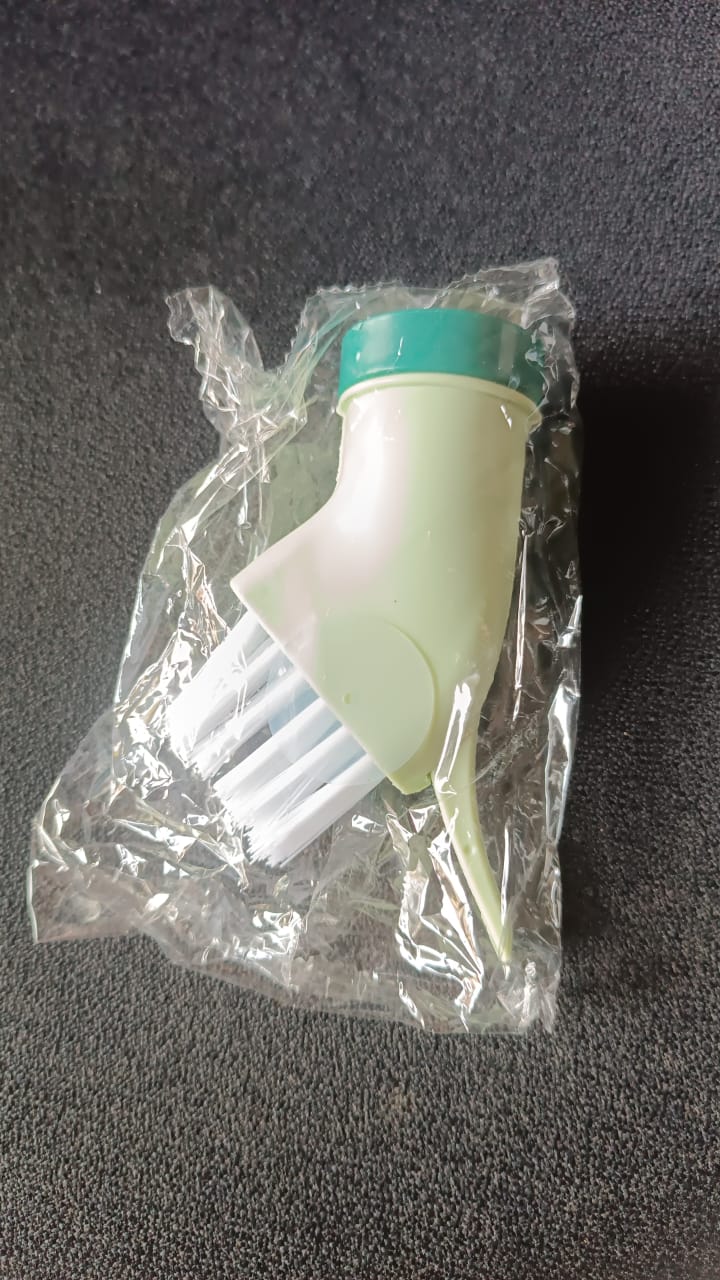 Cleaning brush connected to water bottle for easy water dispensing while scrubbing