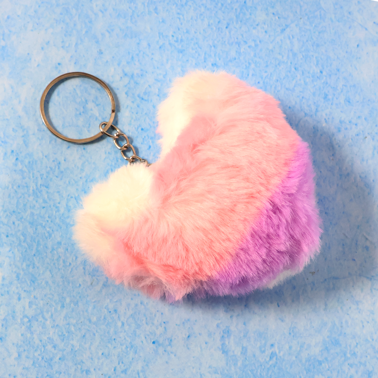 Close-up showing soft plush texture and metal ring of the heart keychain