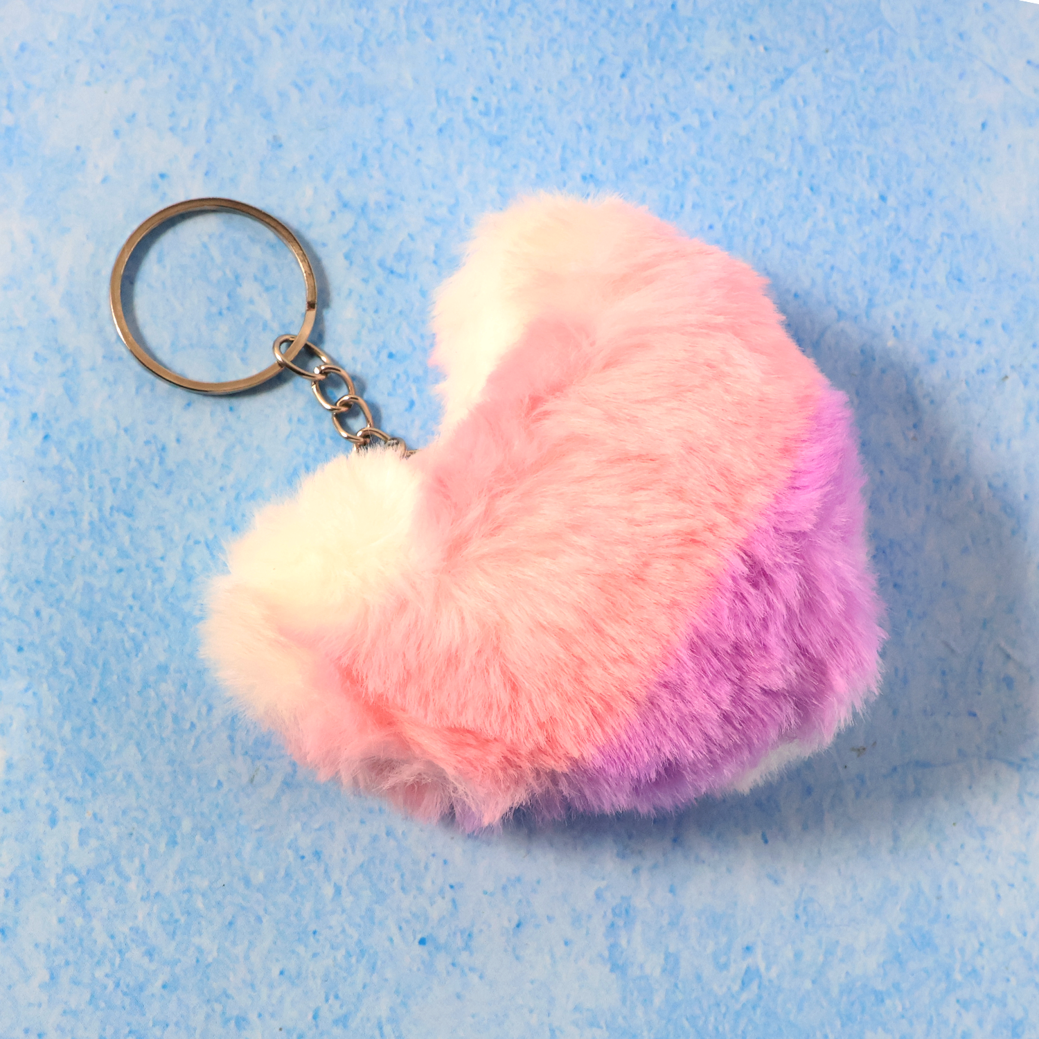 Close-up showing soft plush texture and metal ring of the heart keychain