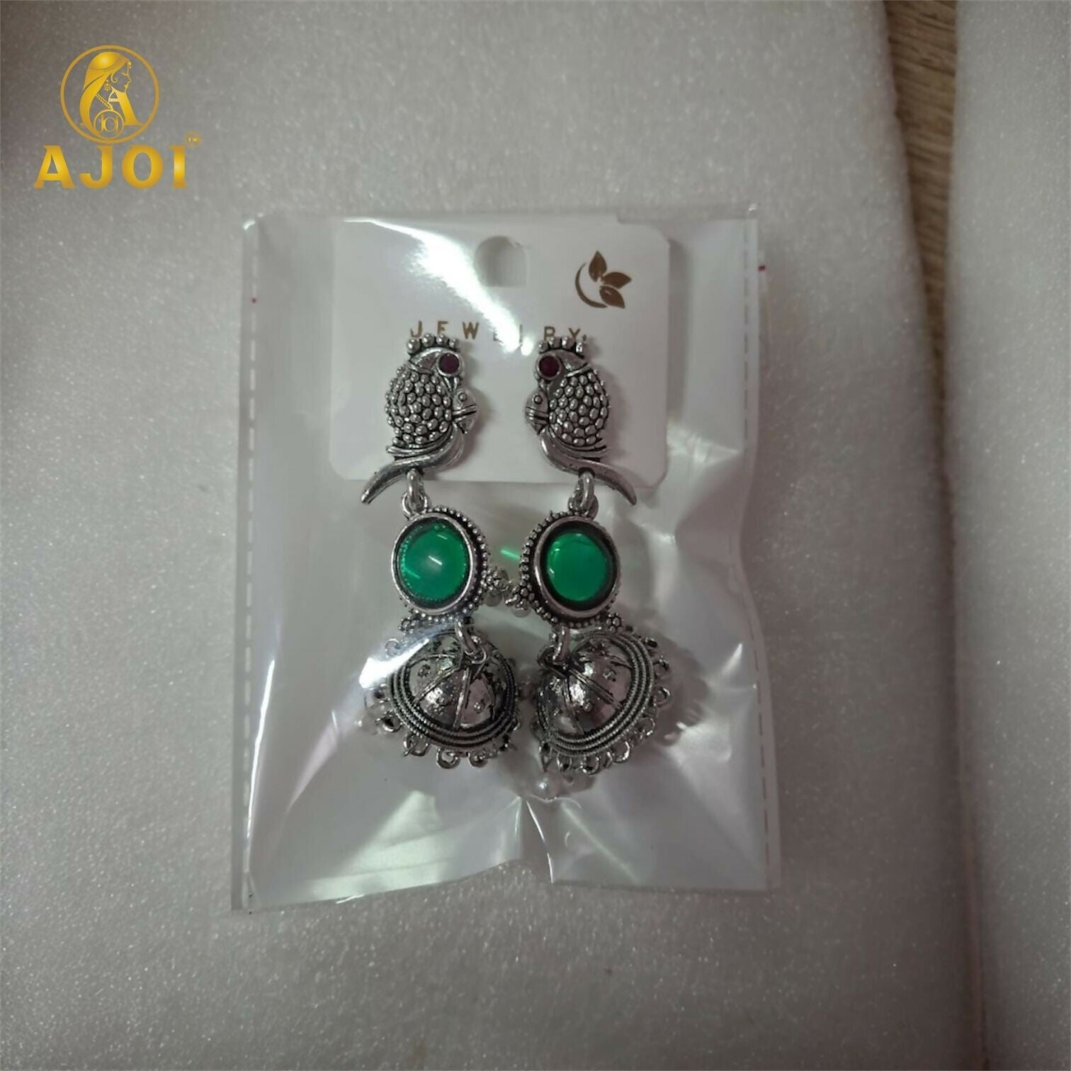 Handcrafted Antique Silver Peacock Jhumka Earrings with Emerald Green Stone & Pearl Drop Detailing