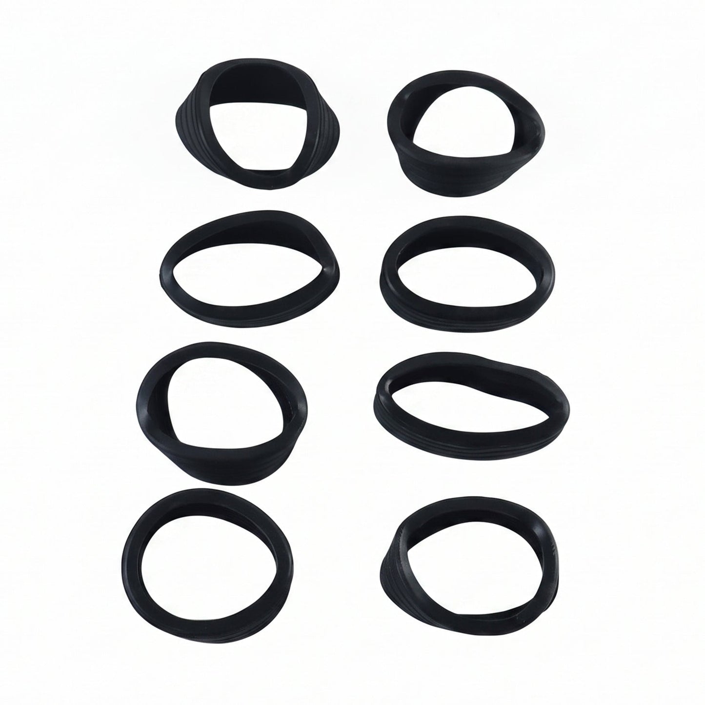 Eight black silicone rings, some slightly distorted, arranged in two vertical rows on a white background.