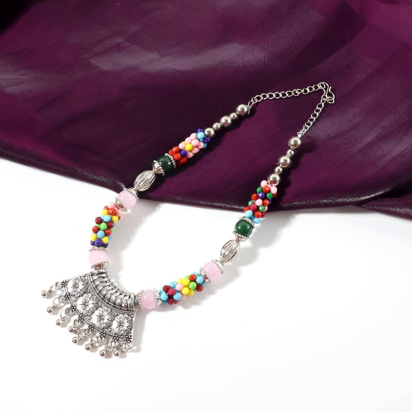 Intricately carved oxidised pendant of multicolor beaded necklace