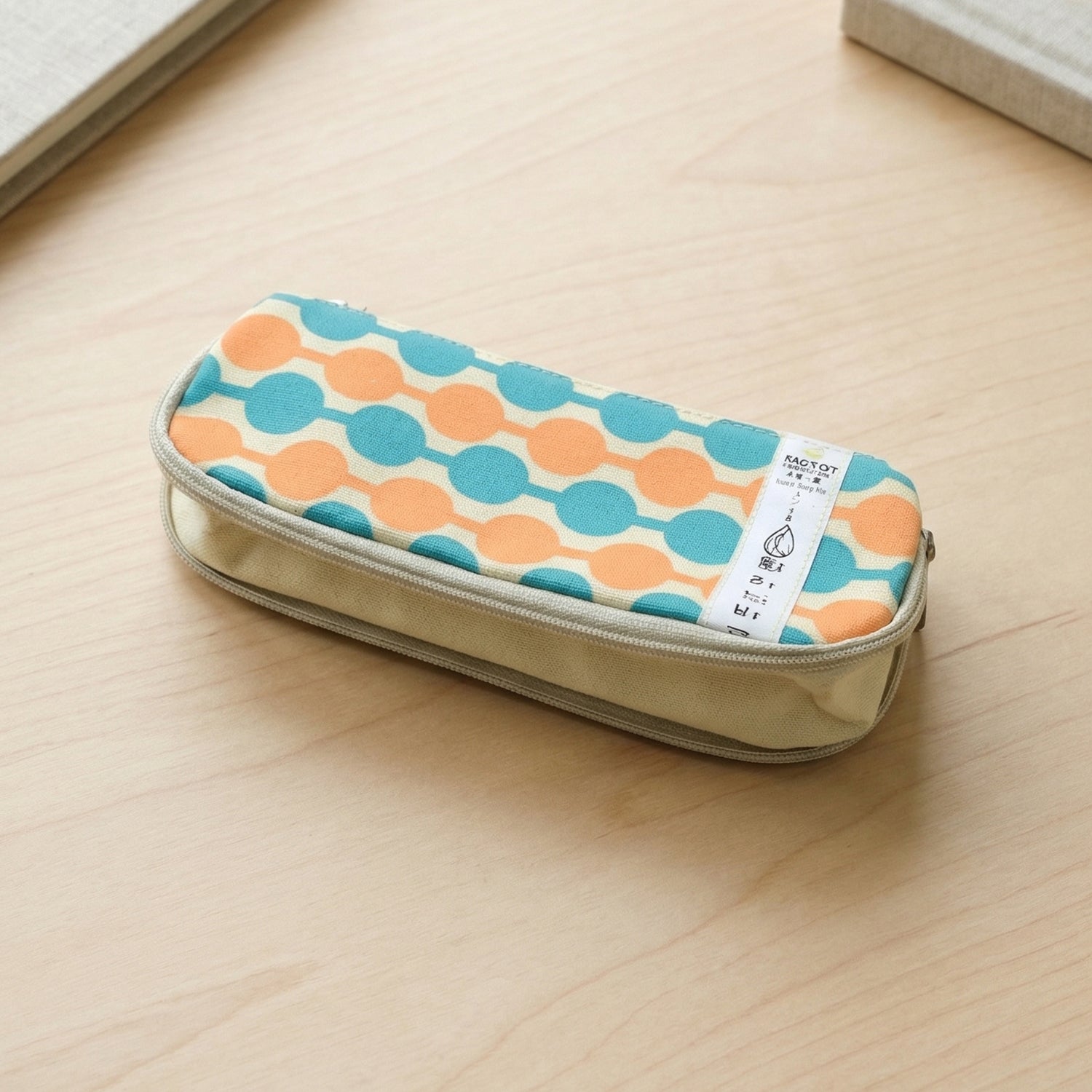 Multiple stationery items stored inside geometric printed pencil pouch