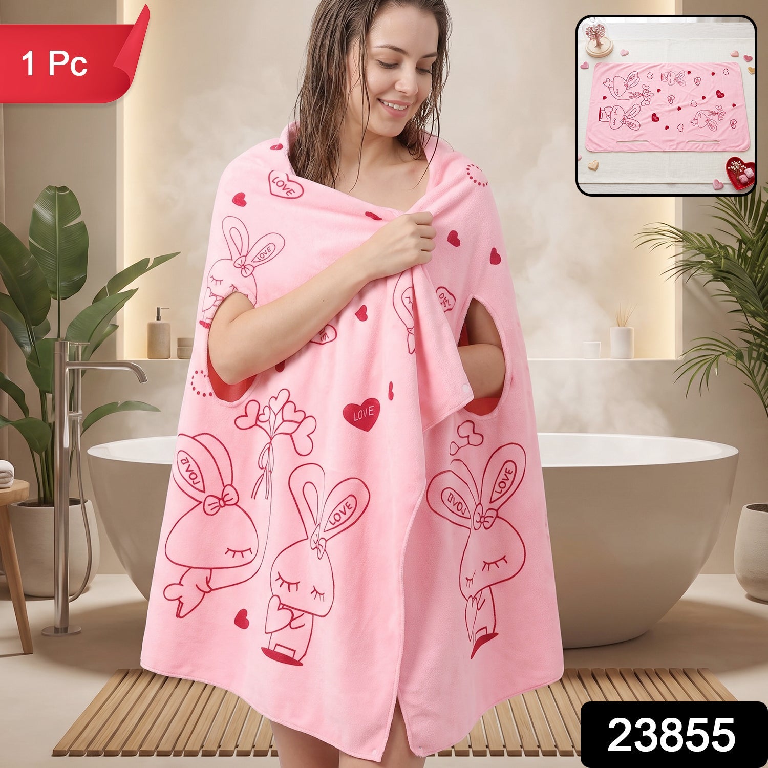 A woman smiles, wrapped in a pink towel with red bunny and heart designs, in a bathroom.