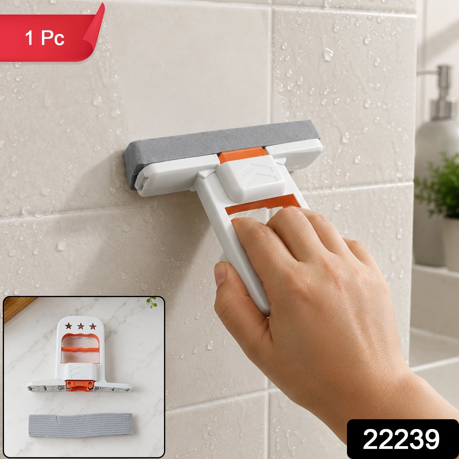 A hand holds a white and orange mini mop with a gray sponge, cleaning a tiled wall with water droplets; a small inset shows