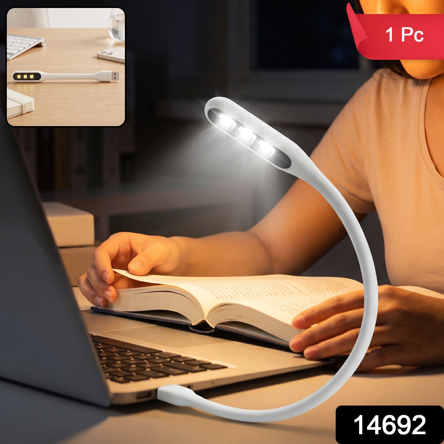 A person reading a book at night with a white flexible USB LED light plugged into a laptop, providing illumination.