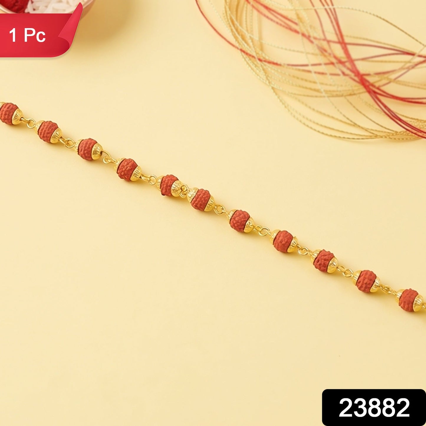 Close up of the rudraksha bead rakhi showing gold plated caps and thread.
