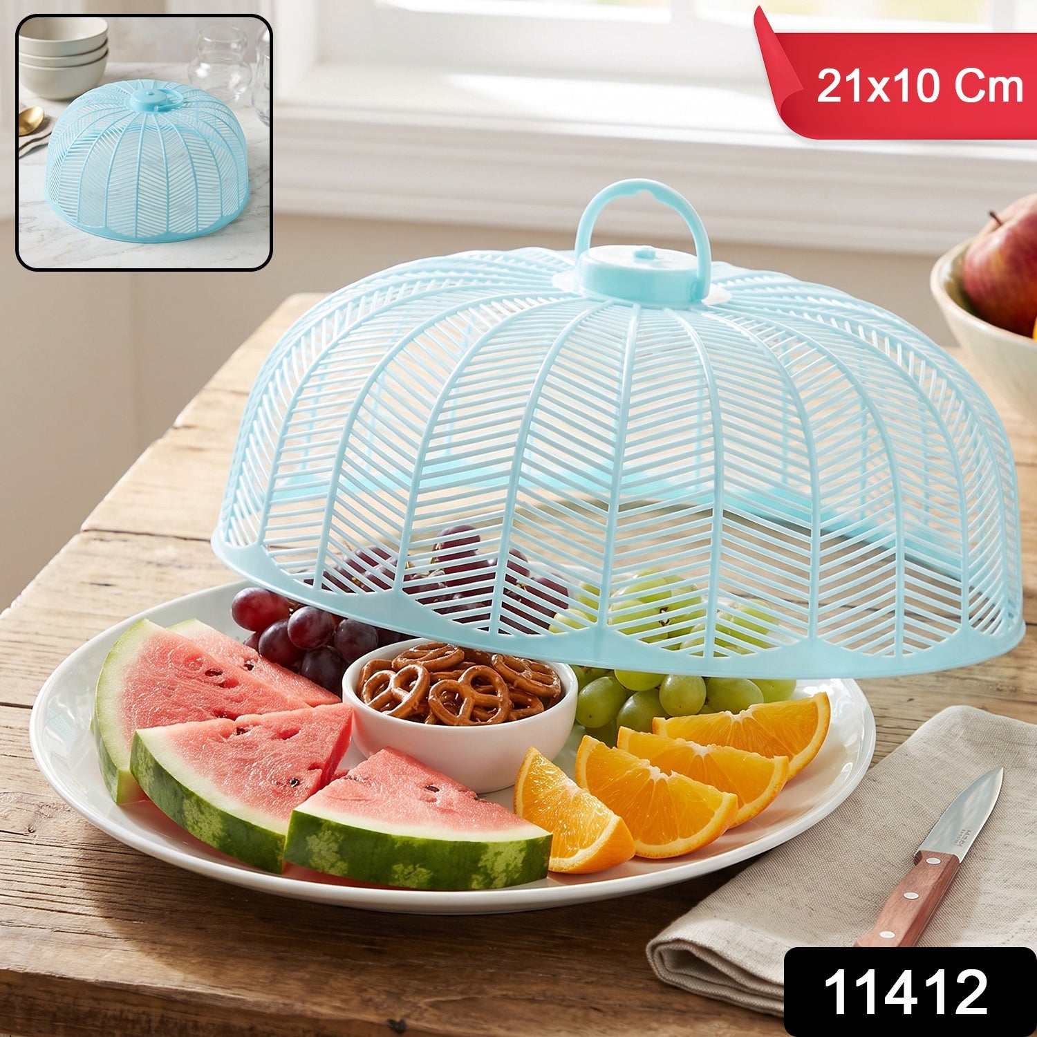 Light blue plastic mesh food cover dome over a white plate with fruit and snacks, with size and product number overlays.