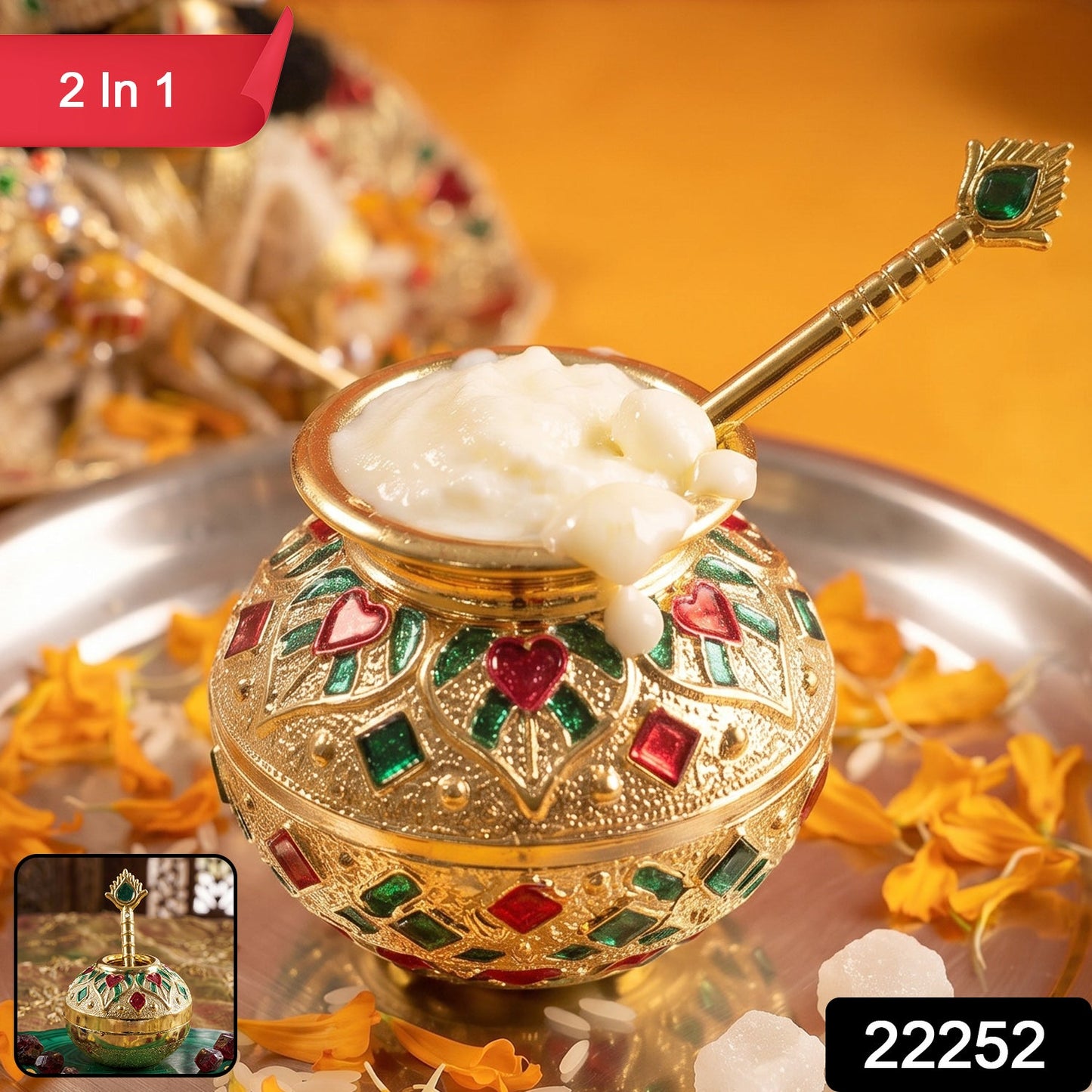 A gold decorative pot and spoon, embellished with red and green enamel, contain white butter on a silver tray with a 2 In 1