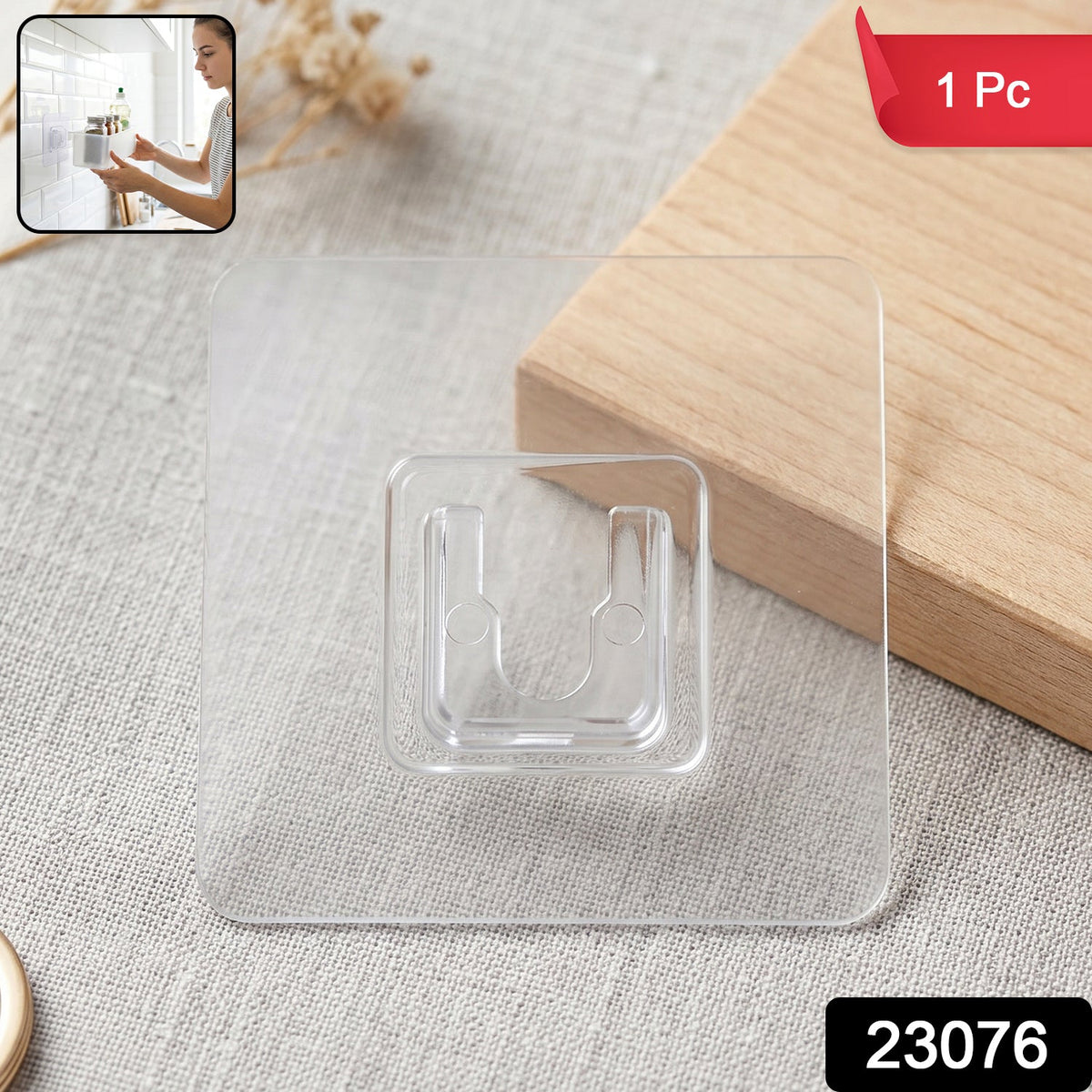 A clear self-adhesive hook is on a light gray surface with a wooden block behind it, and a small inset image of a woman.
